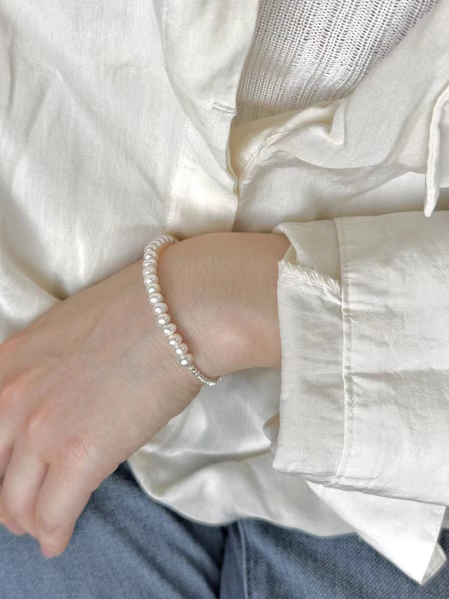 A beautiful Broken Silver Natural Pearl Bracelet and Necklace featuring natural pearls and gold vermeil on sterling silver, showcasing elegance and craftsmanship.