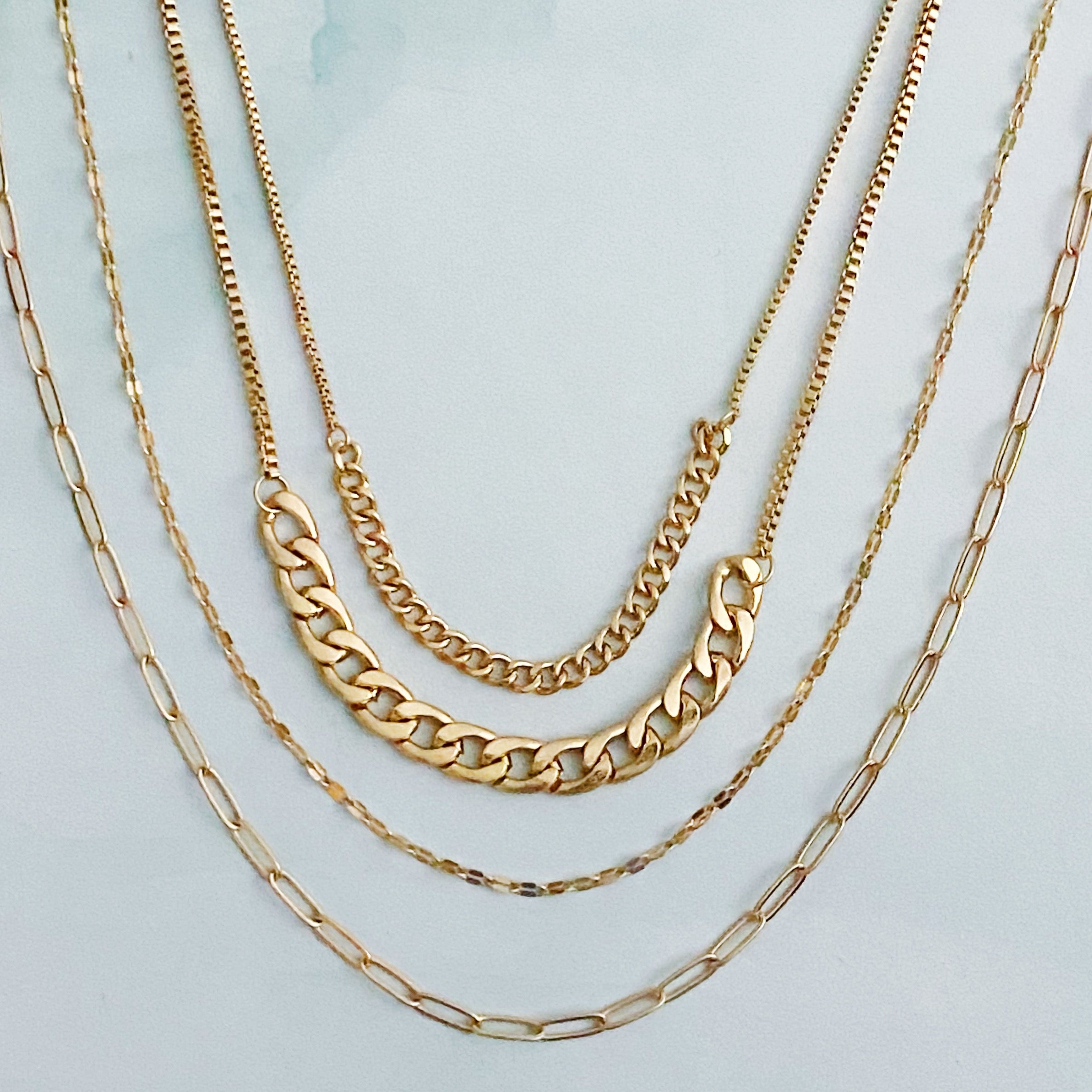 Brooklyn Four Chains Necklace Set of 3 featuring layered Cuban, link, and textured chains in alloy metal.