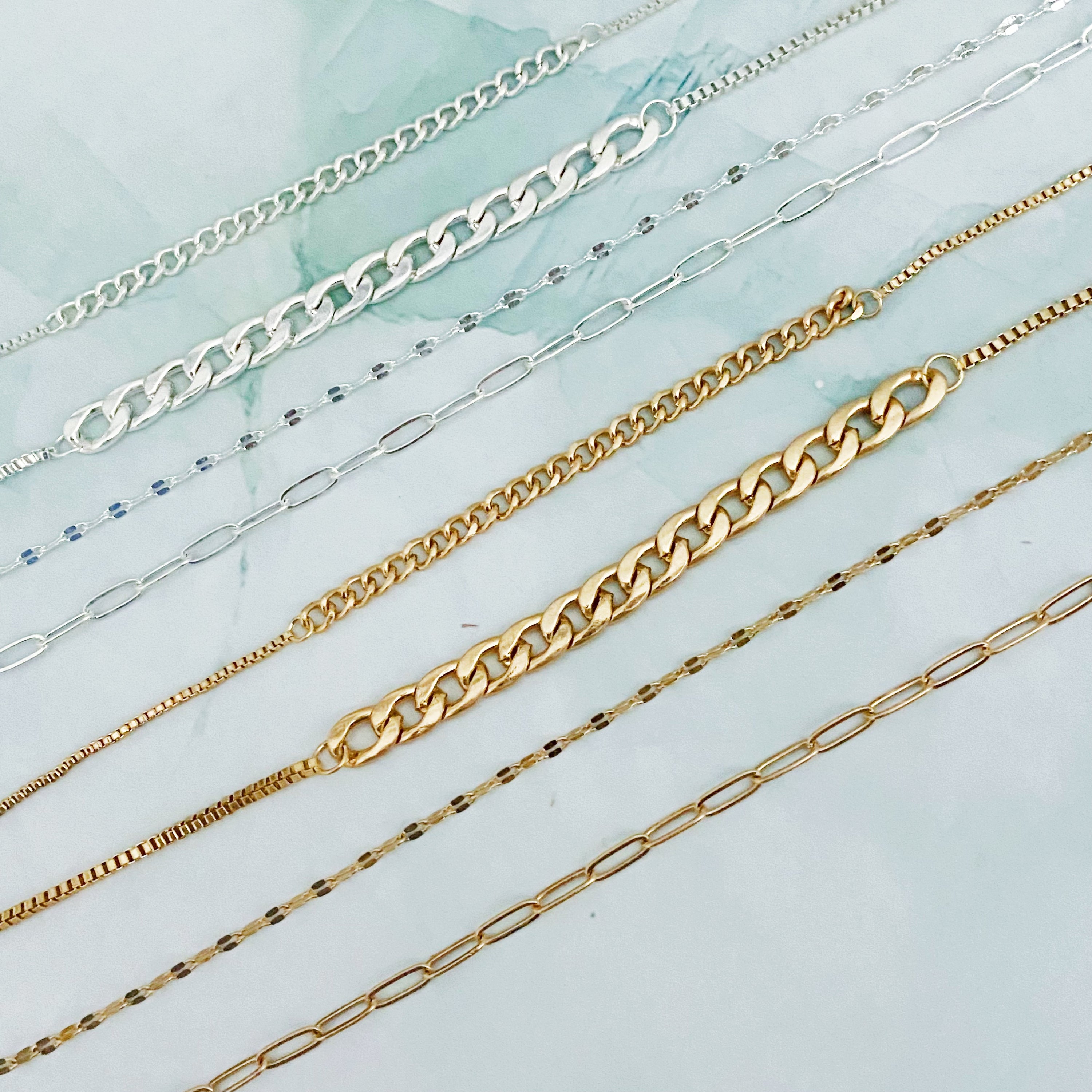 Brooklyn Four Chains Necklace Set of 3 featuring layered Cuban, link, and textured chains in alloy metal.