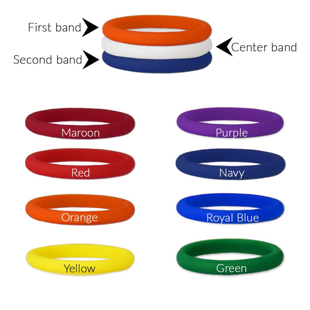 A set of customizable stackable silicone rings featuring a plain white center band, displayed in various colors.