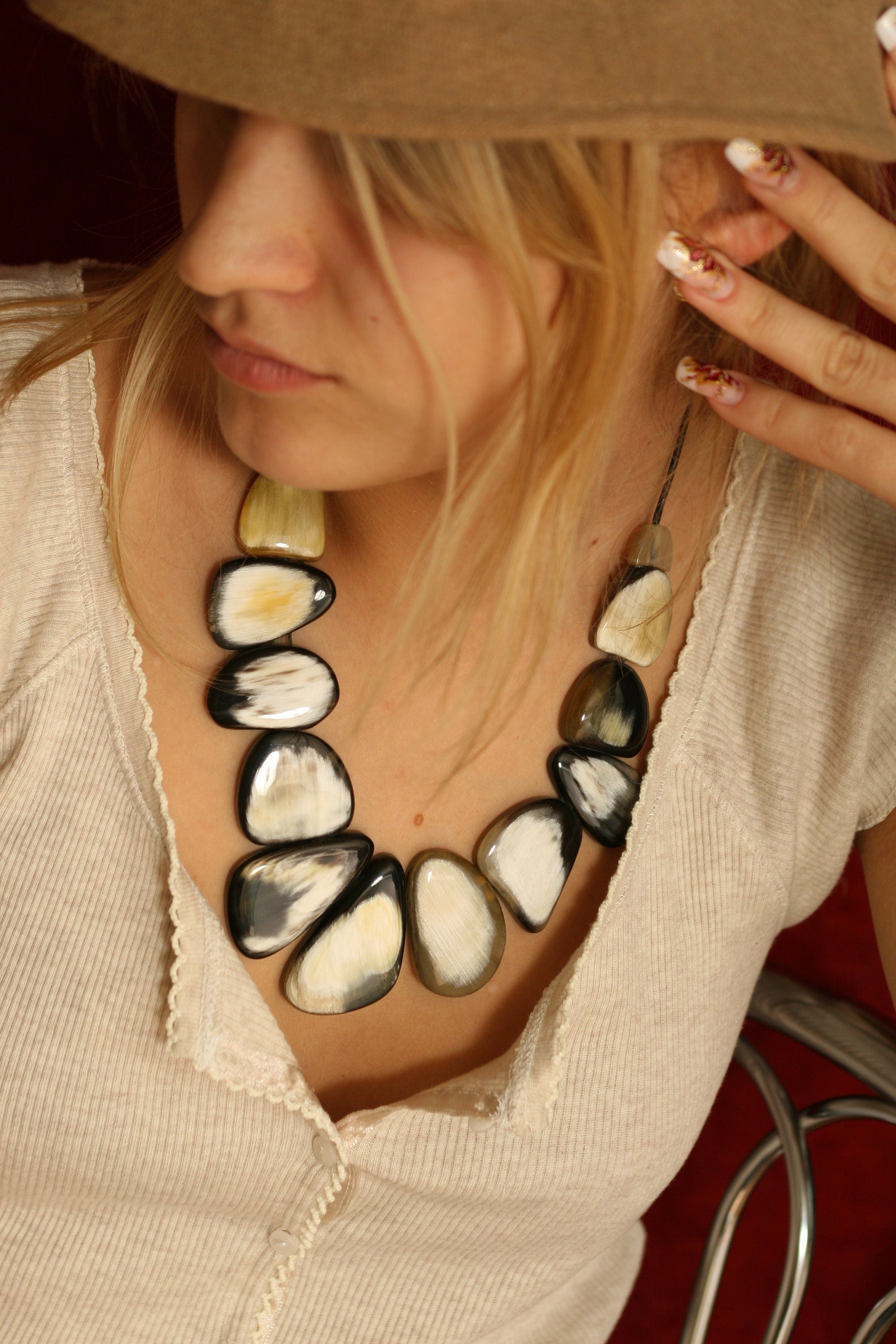 Handmade bull horn necklace featuring polished ovals and leather cord, showcasing natural beauty and elegance.