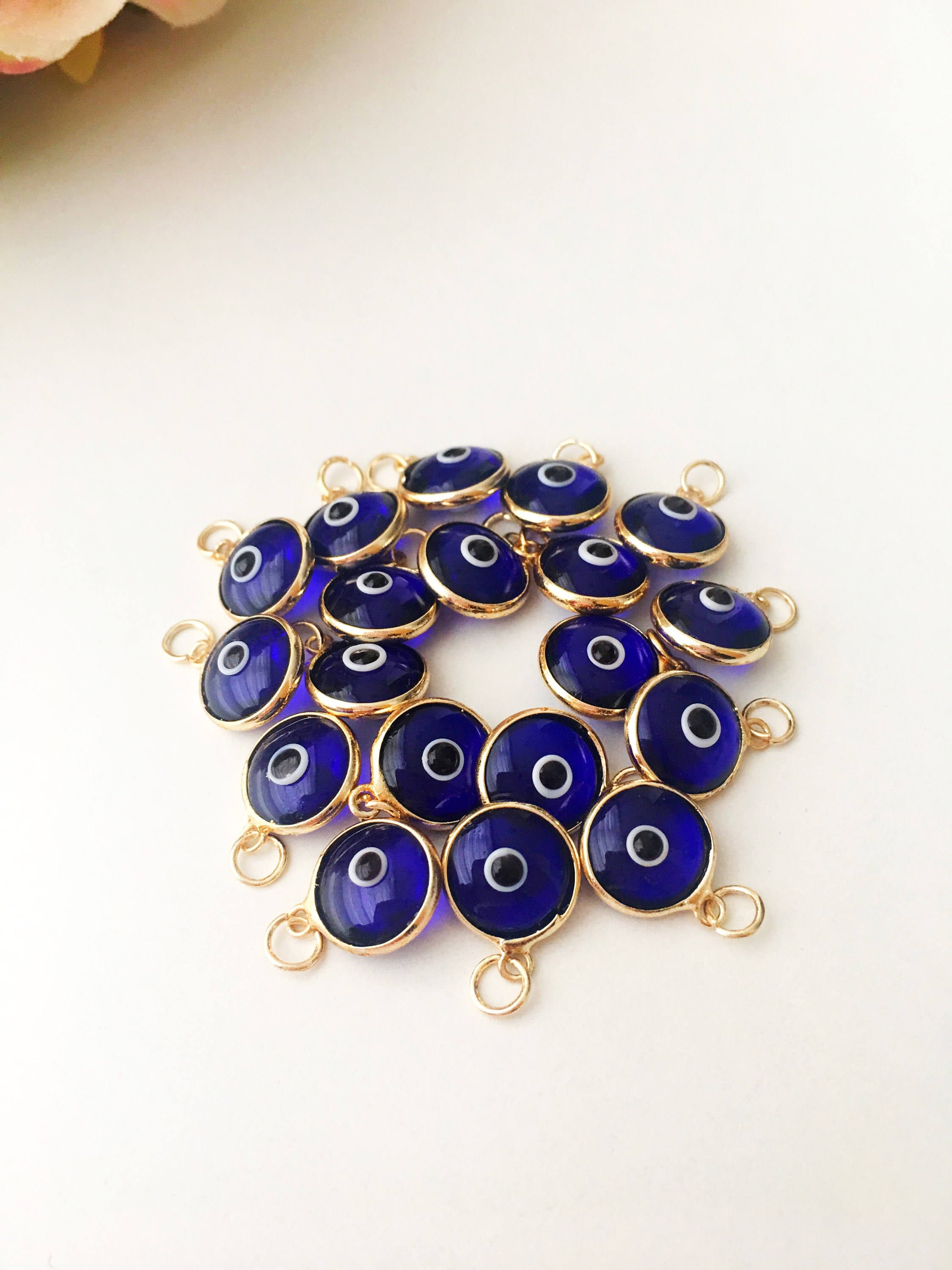 A bulk set of blue evil eye beads, showcasing their vibrant color and intricate design, perfect for jewelry making.