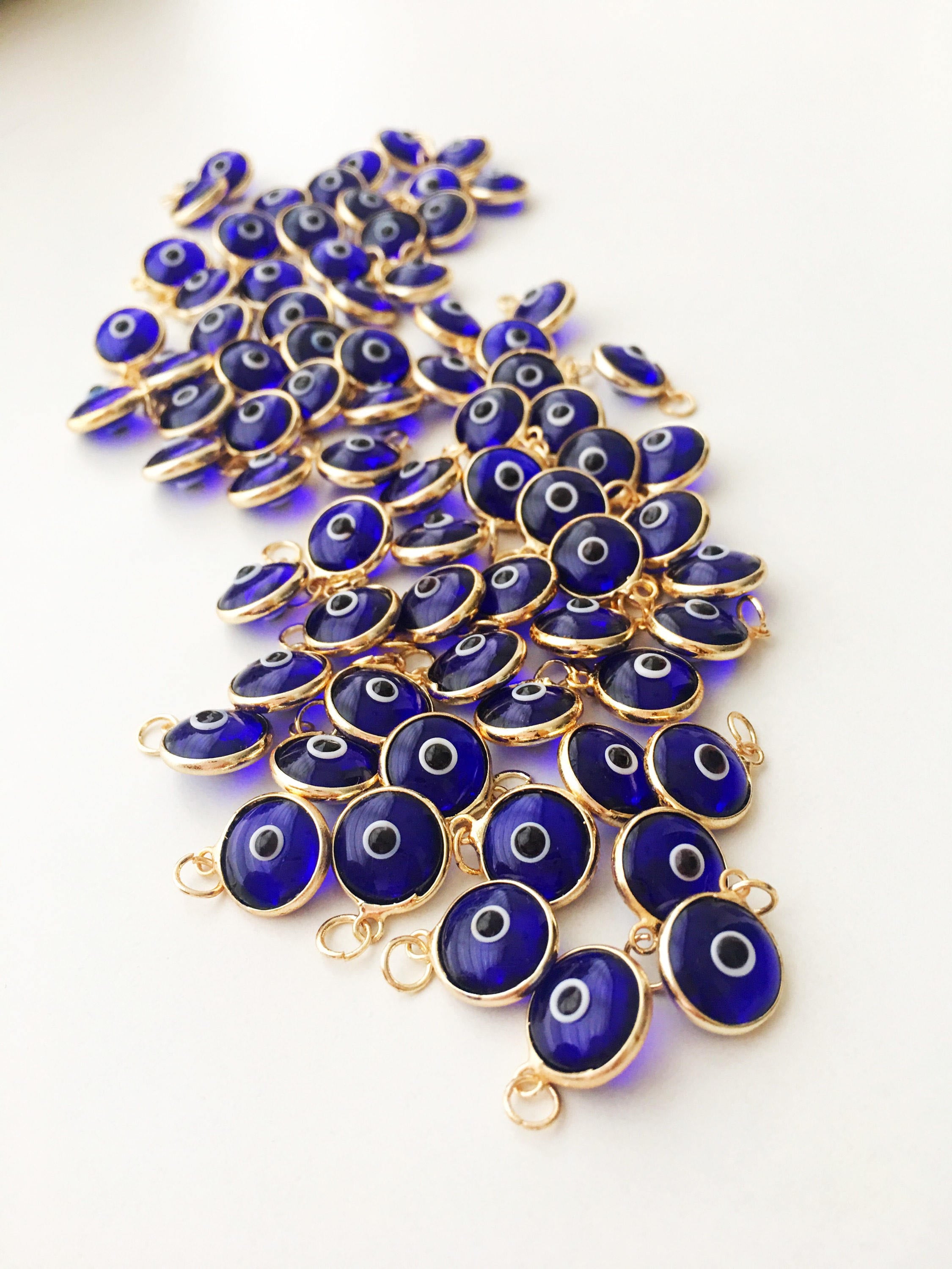 A bulk set of blue evil eye beads, showcasing their vibrant color and intricate design, perfect for jewelry making.