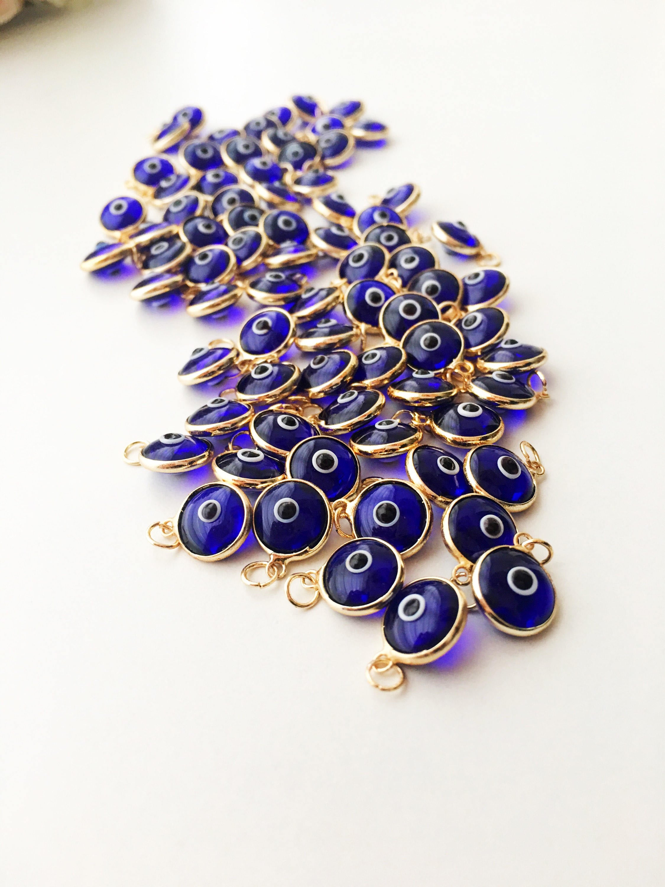 A bulk set of blue evil eye beads, showcasing their vibrant color and intricate design, perfect for jewelry making.