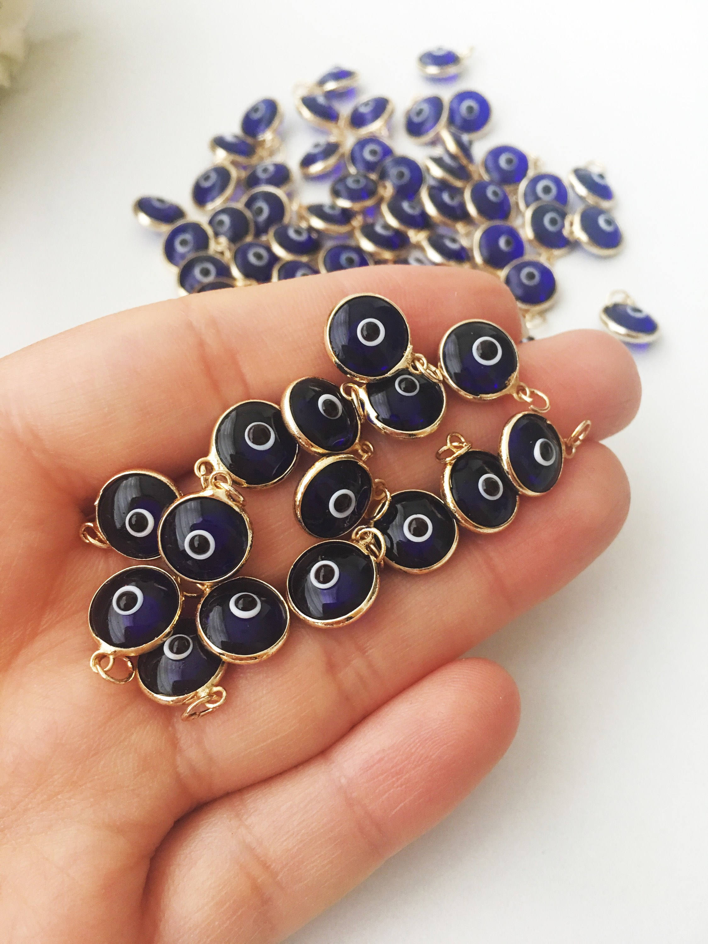 A bulk set of blue evil eye beads, showcasing their vibrant color and intricate design, perfect for jewelry making.