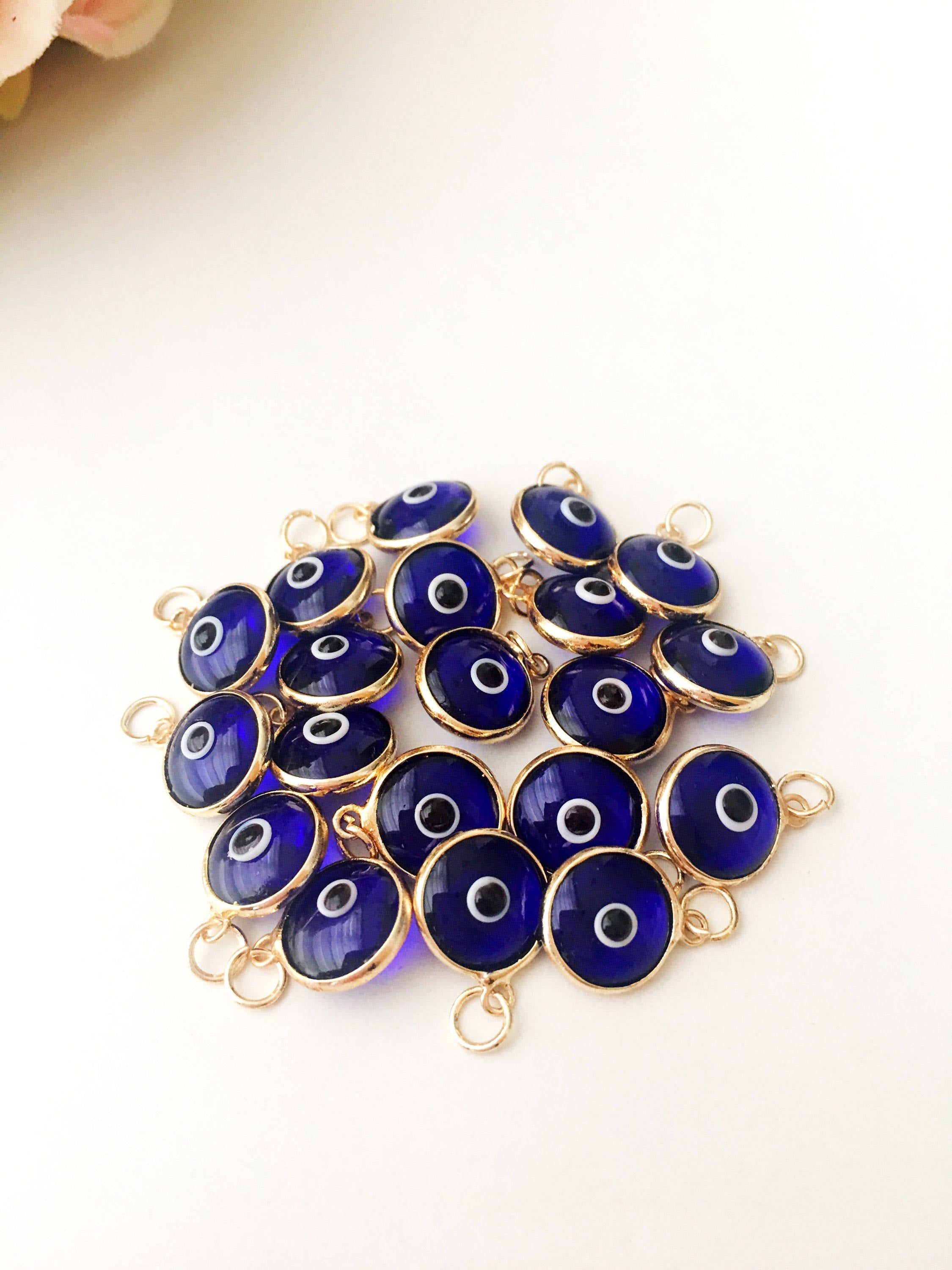 A bulk set of blue evil eye beads, showcasing their vibrant color and intricate design, perfect for jewelry making.