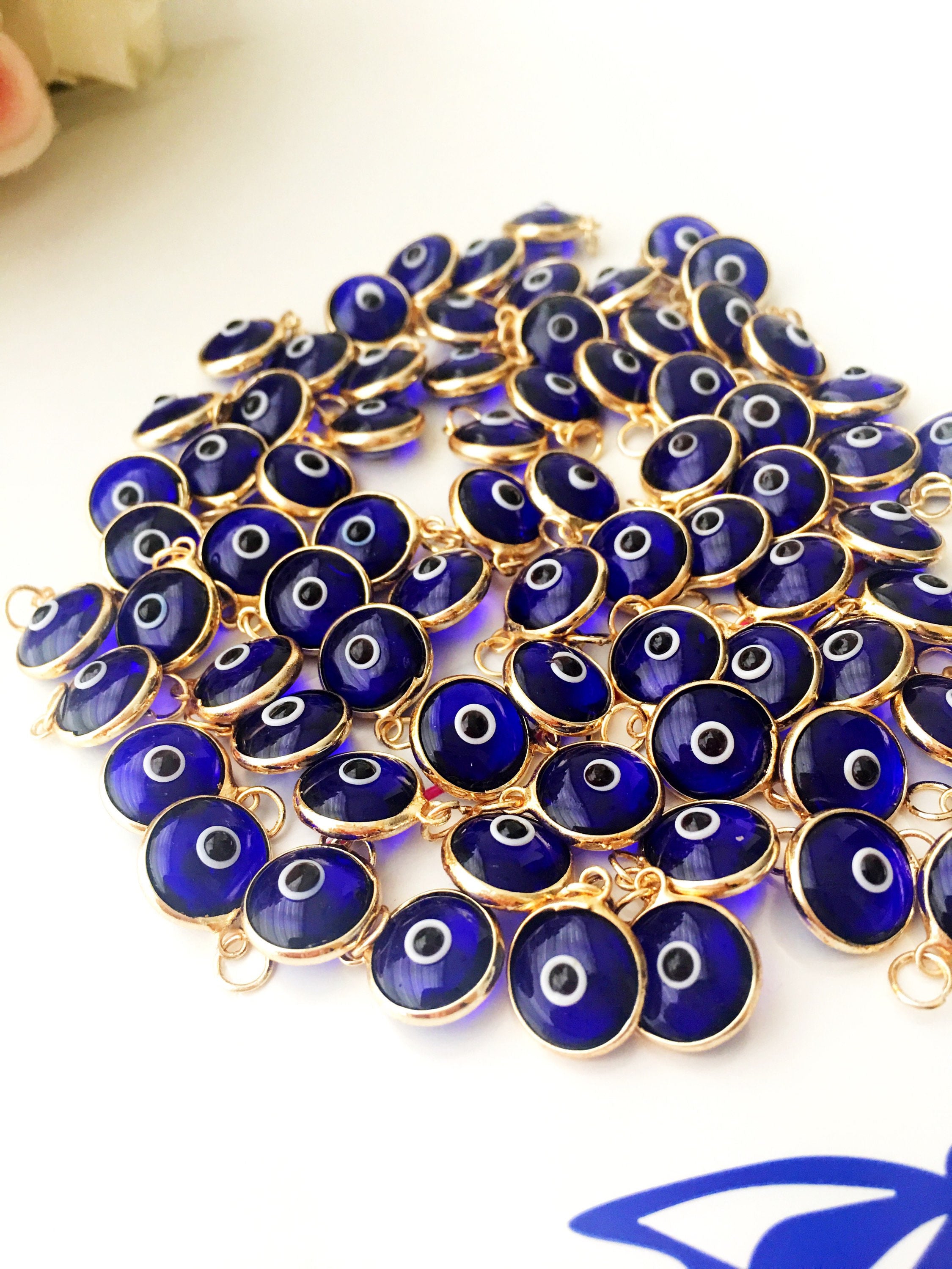 A bulk set of blue evil eye beads, showcasing their vibrant color and intricate design, perfect for jewelry making.