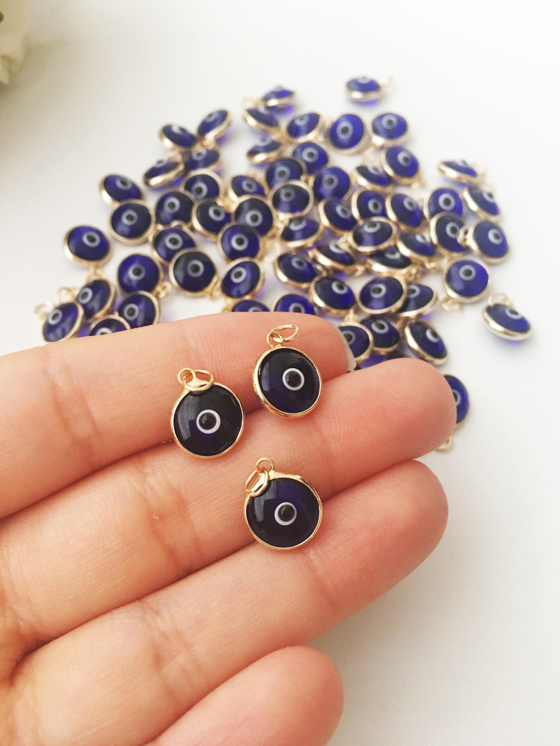 A bulk set of blue evil eye beads, showcasing their vibrant color and intricate design, perfect for jewelry making.