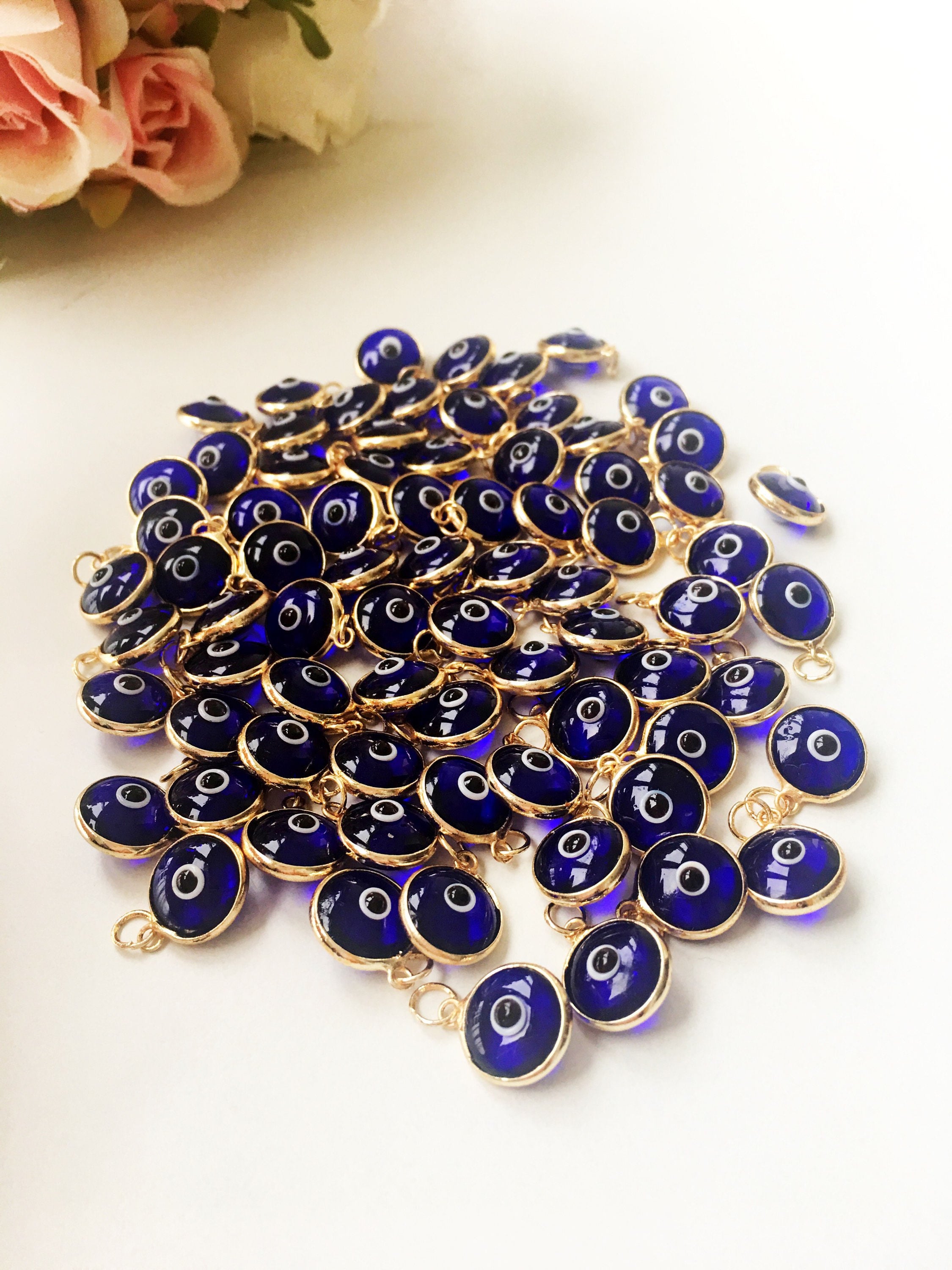 A bulk set of blue evil eye beads, showcasing their vibrant color and intricate design, perfect for jewelry making.