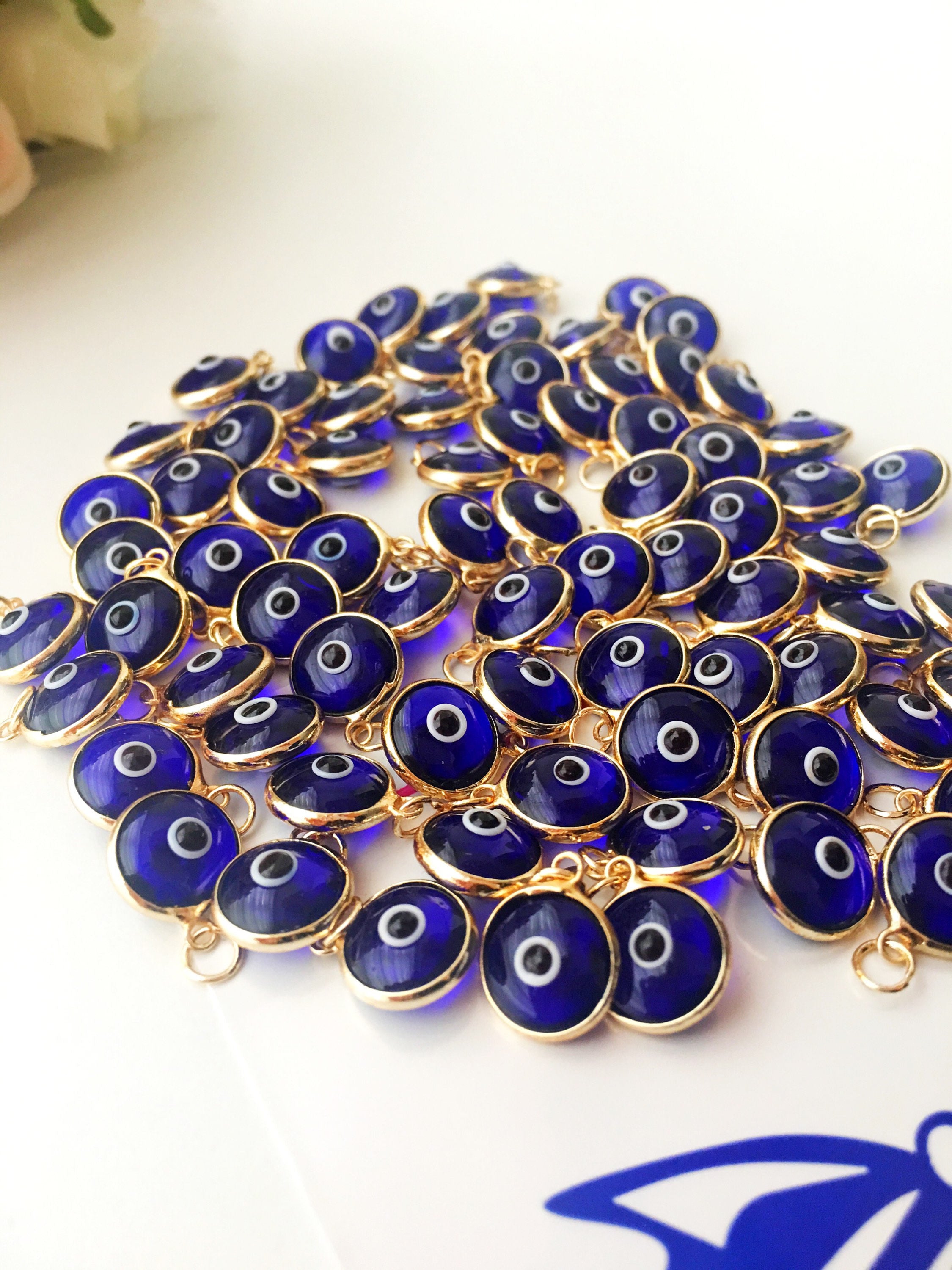 A bulk set of blue evil eye beads, showcasing their vibrant color and intricate design, perfect for jewelry making.