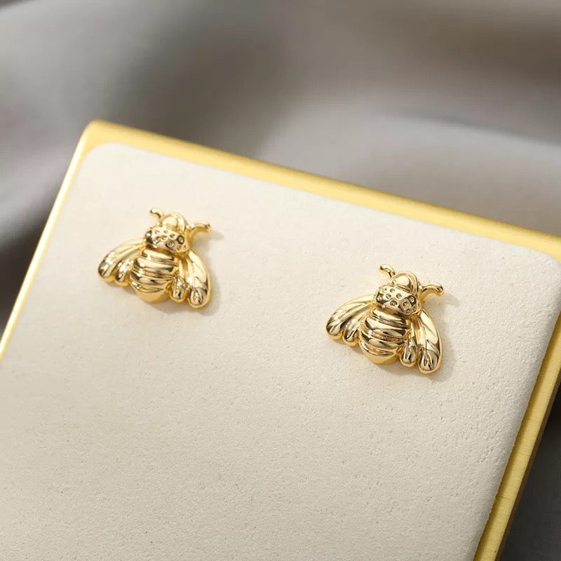 A pair of stylish Bumble Bee Stud Earrings made from plated copper, featuring intricate bee designs.