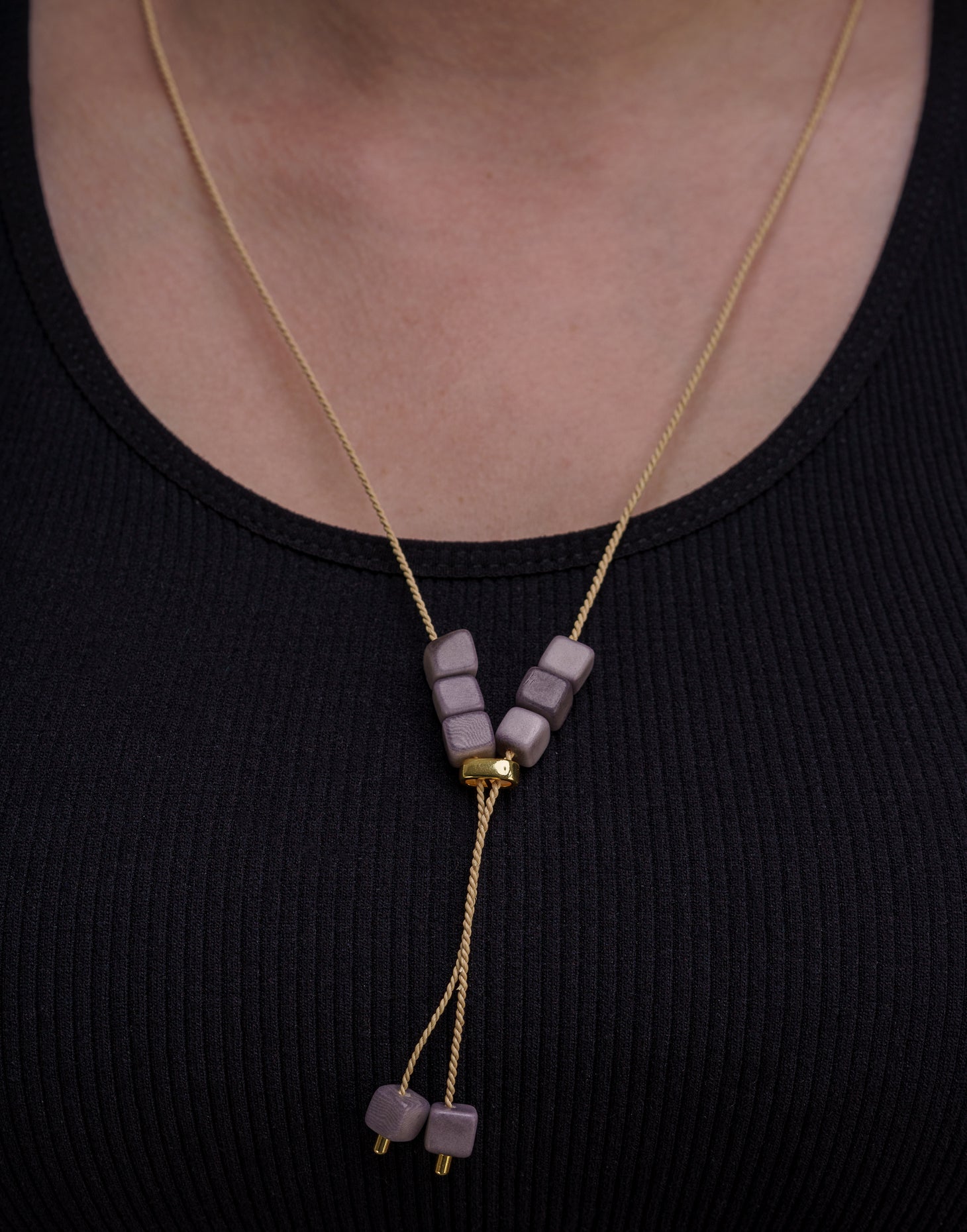 Buriti Lariat Tagua Necklace featuring a handcut tagua nut and Buriti palm cord, elegantly designed for a boho-chic look.