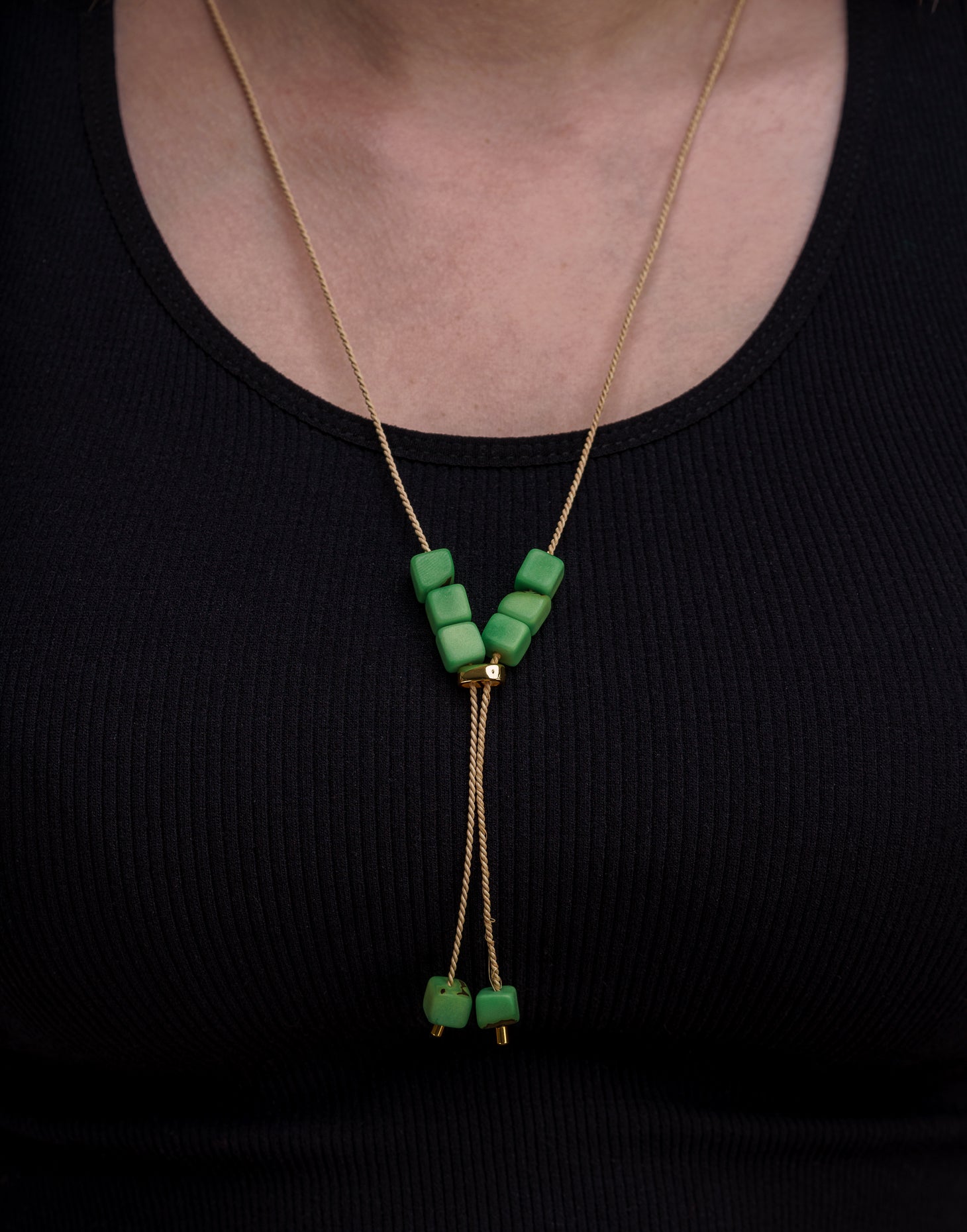 Buriti Lariat Tagua Necklace featuring a handcut tagua nut and Buriti palm cord, elegantly designed for a boho-chic look.