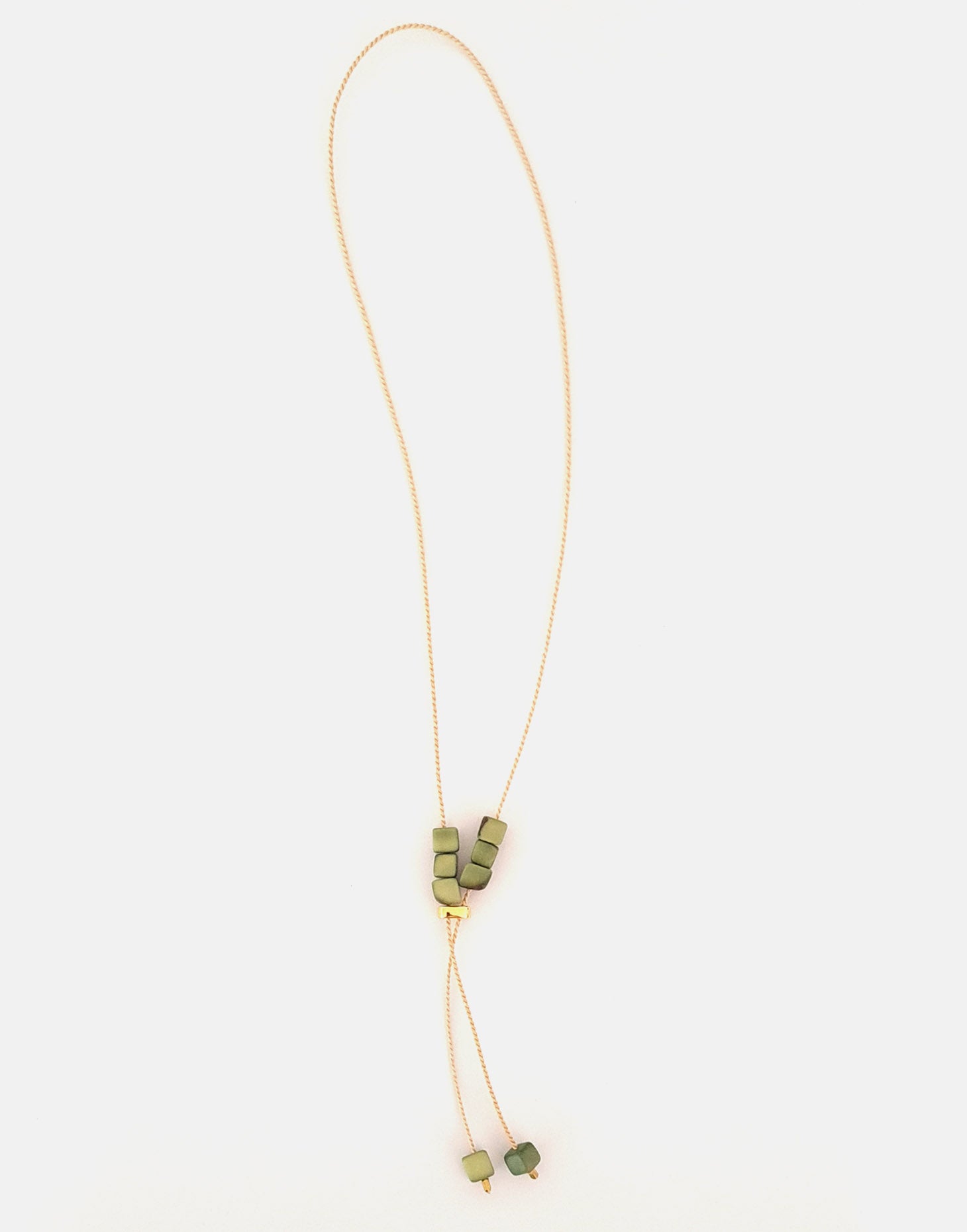 Buriti Lariat Tagua Necklace featuring a handcut tagua nut and Buriti palm cord, elegantly designed for a boho-chic look.