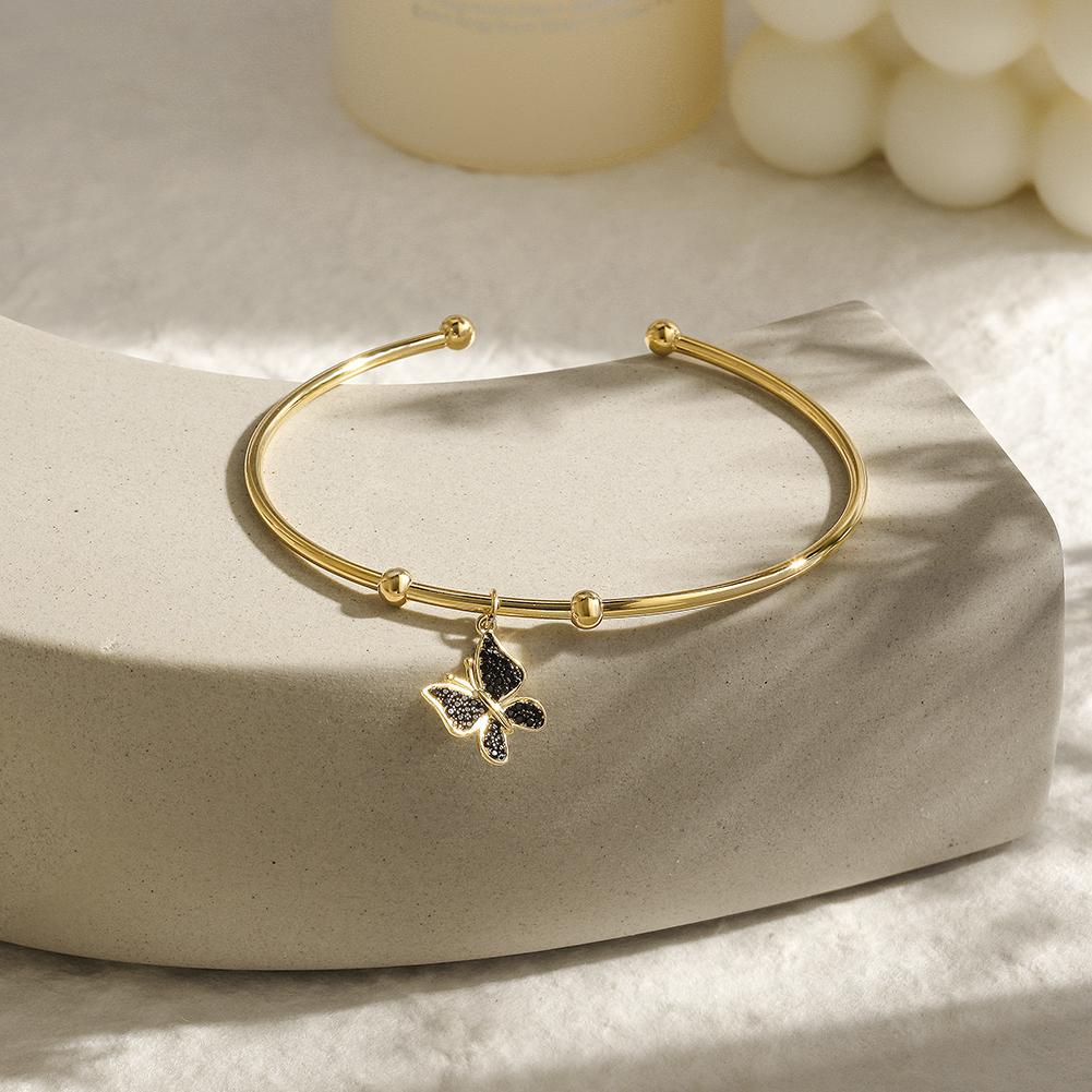 Sterling silver Butterfly Cuff bangle featuring a tiny butterfly charm, elegantly designed for stylish wear.