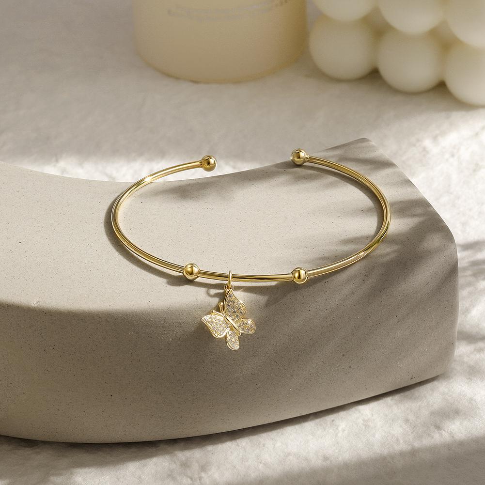 Sterling silver Butterfly Cuff bangle featuring a tiny butterfly charm, elegantly designed for stylish wear.