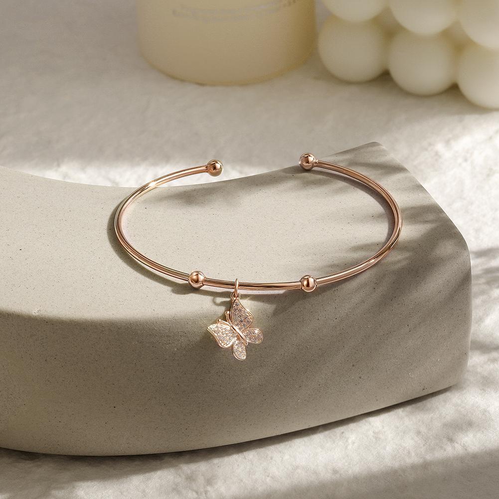 Sterling silver Butterfly Cuff bangle featuring a tiny butterfly charm, elegantly designed for stylish wear.