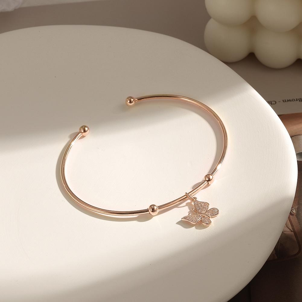 Sterling silver Butterfly Cuff bangle featuring a tiny butterfly charm, elegantly designed for stylish wear.