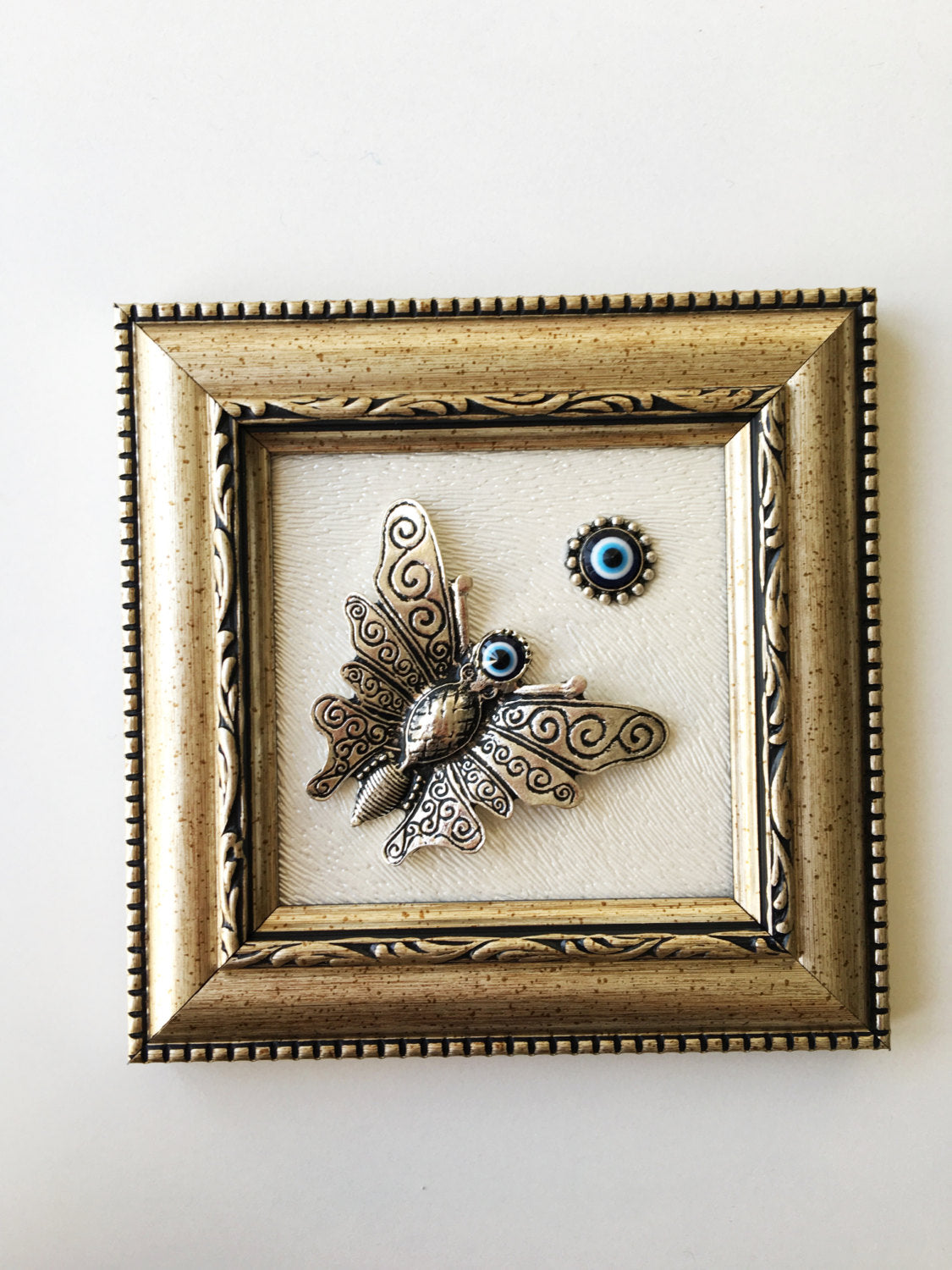 Handmade Butterfly Evil Eye Wall Decor featuring a silver butterfly and a small evil eye, perfect for home decoration.