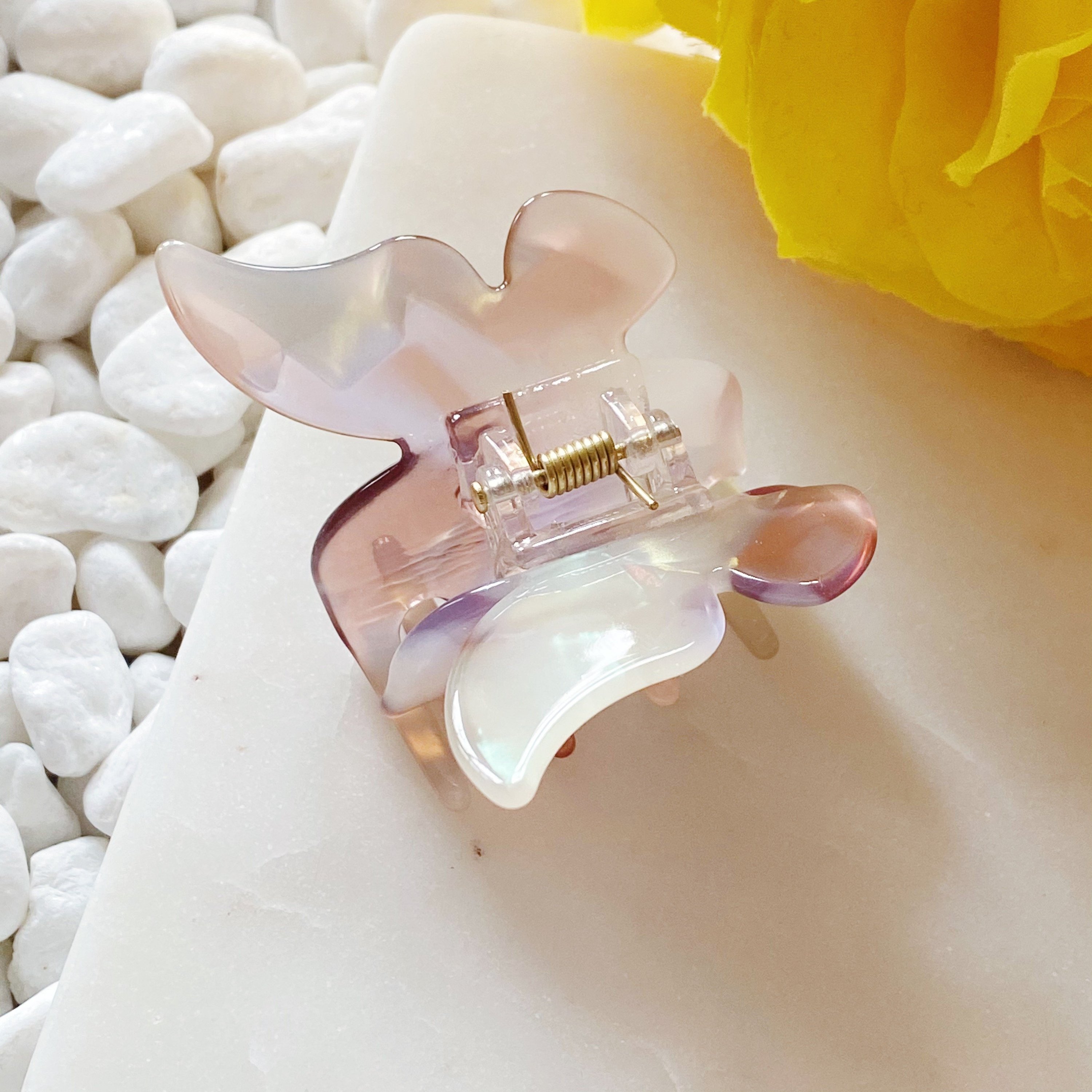 A stylish butterfly-shaped acrylic hair claw in elegant design, perfect for securing hair in various styles.