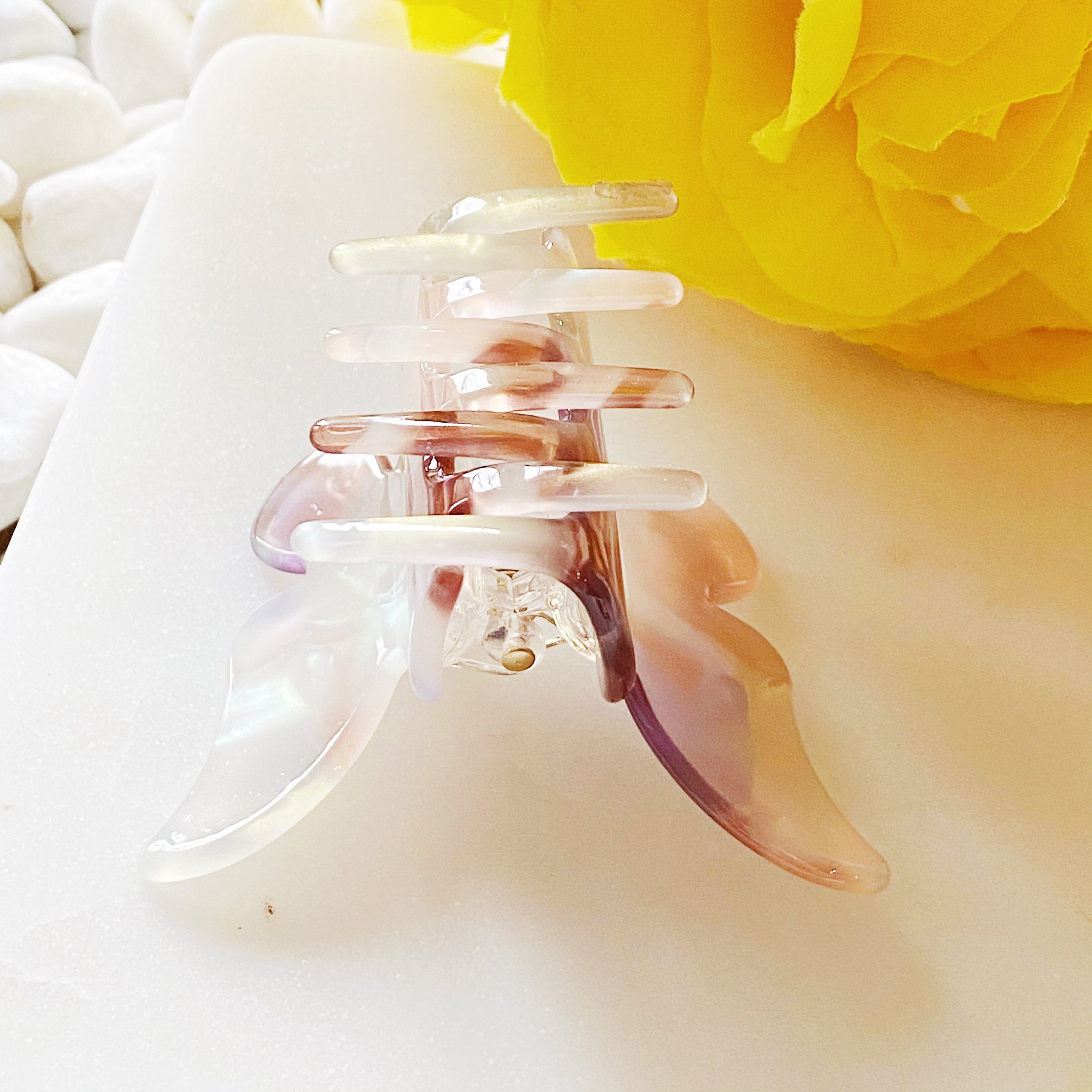 A stylish butterfly-shaped acrylic hair claw in elegant design, perfect for securing hair in various styles.