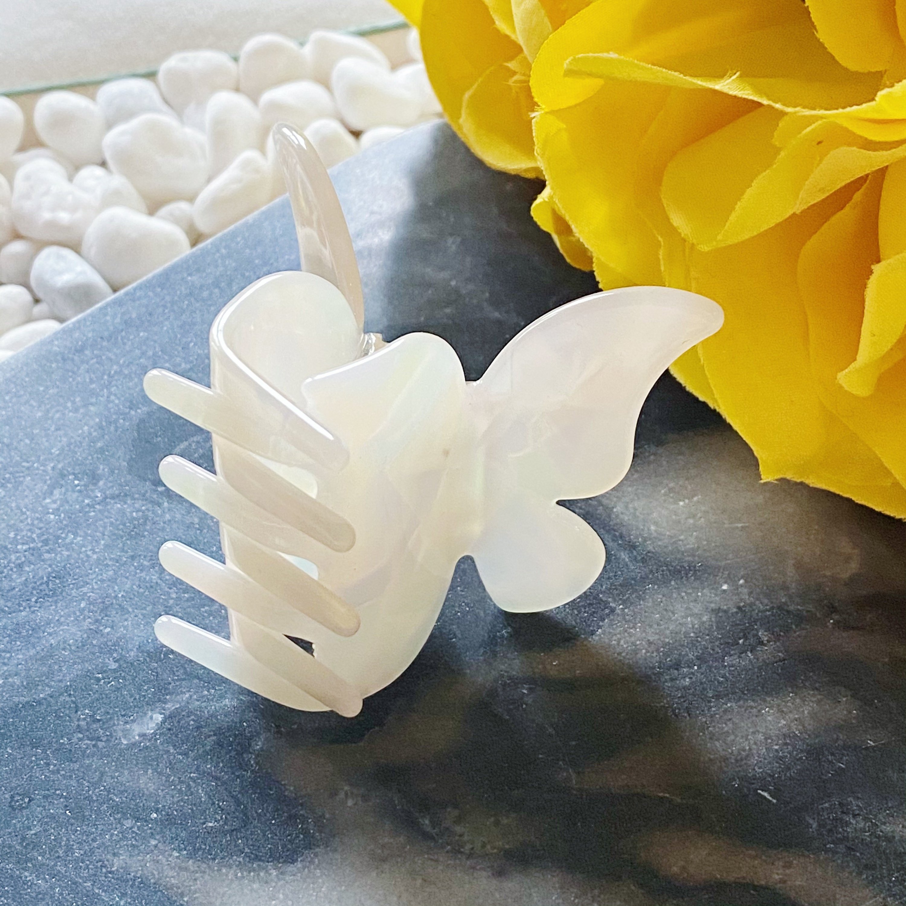 A stylish butterfly-shaped acrylic hair claw in elegant design, perfect for securing hair in various styles.