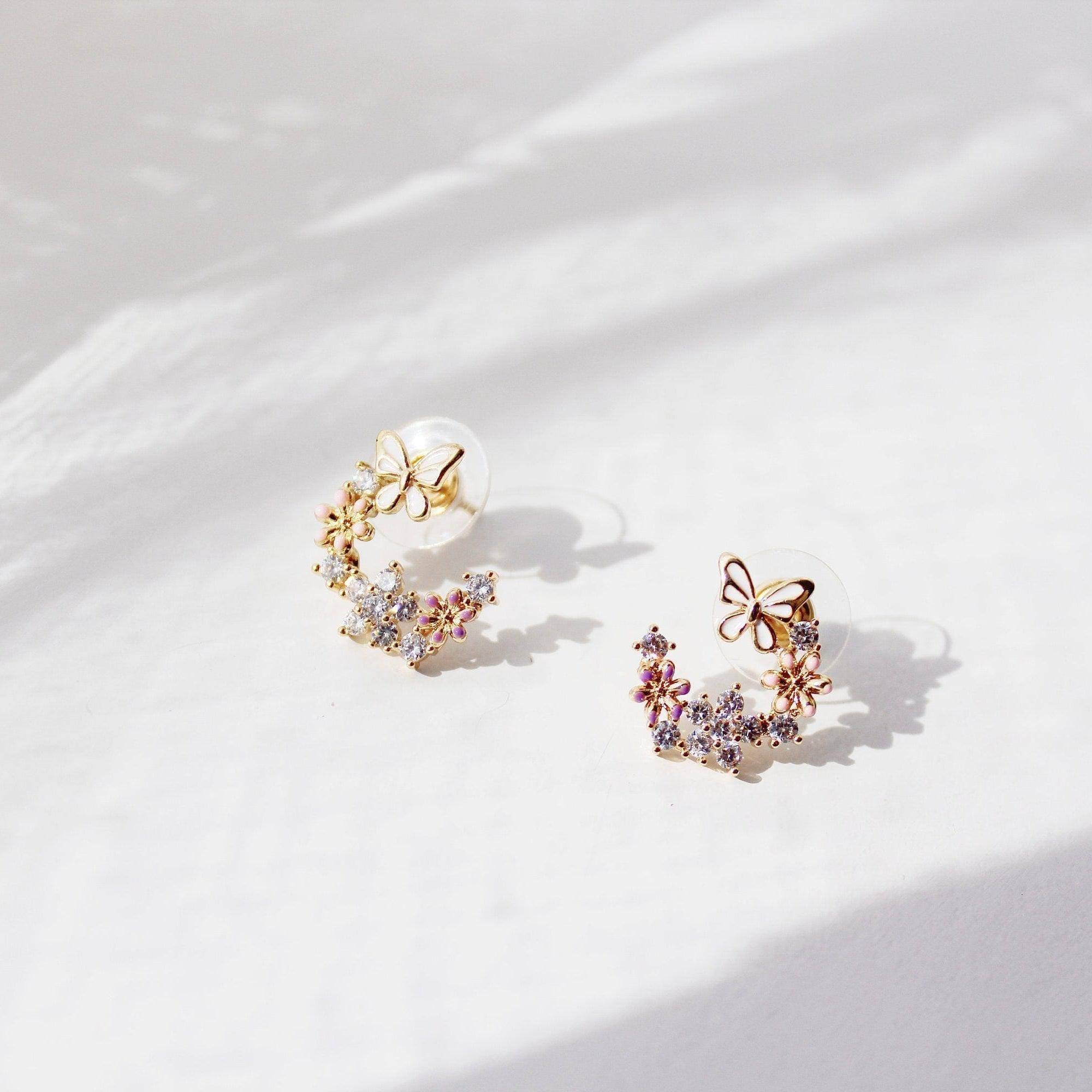 Elegant butterfly earrings featuring cherry blossom design, crafted from sterling silver and gold plated bronze.