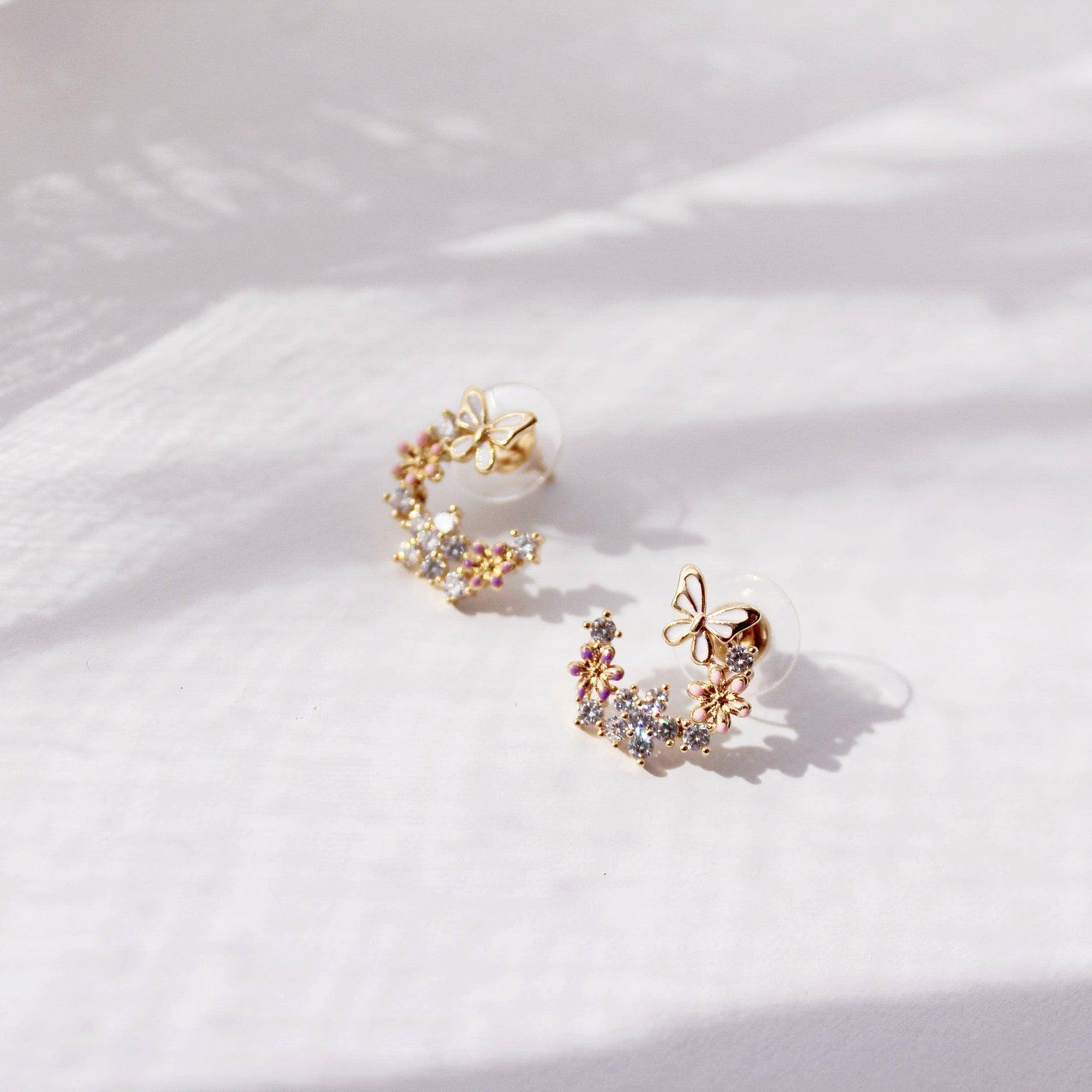 Elegant butterfly earrings featuring cherry blossom design, crafted from sterling silver and gold plated bronze.