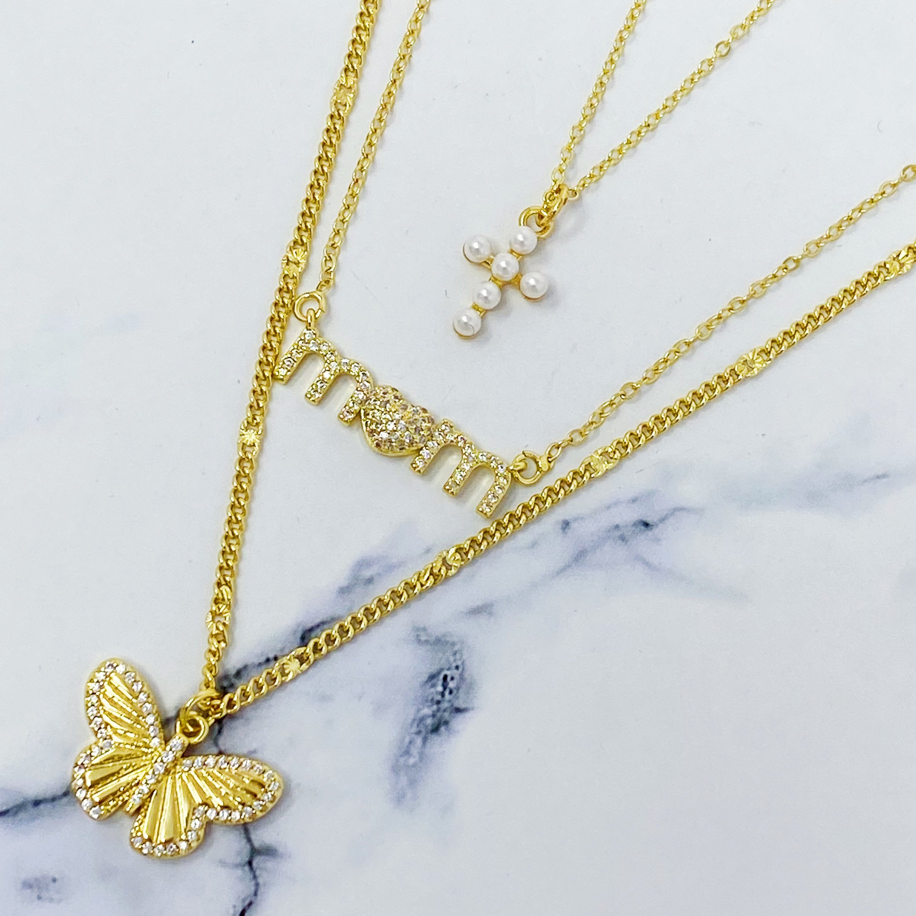 A delicate Butterfly In Flight Necklace featuring a detailed butterfly charm embellished with cubic zirconia stones on a gold plated brass chain.