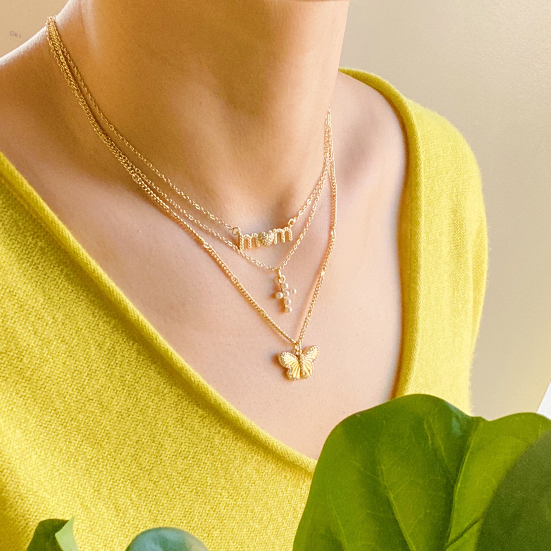 A delicate Butterfly In Flight Necklace featuring a detailed butterfly charm embellished with cubic zirconia stones on a gold plated brass chain.