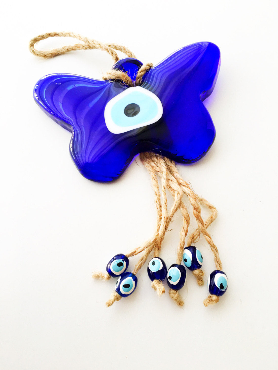 A beautifully crafted Butterfly Macrame Evil Eye Wall Hanging featuring a glass evil eye charm, showcasing intricate macrame design.