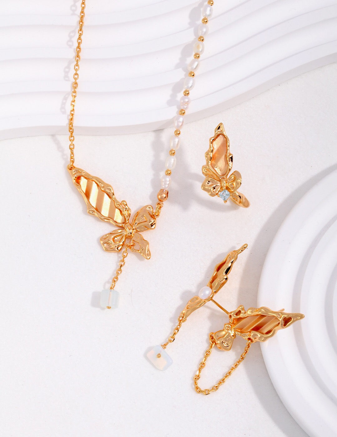 A delicate Butterfly Pearl Necklace made of sterling silver and gold vermeil, featuring a butterfly design with a lustrous pearl.