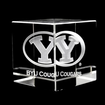 A beautifully crafted BYU Crystal Cube showcasing the BYU logo inside a clear optical crystal, reflecting light with sharp angles.