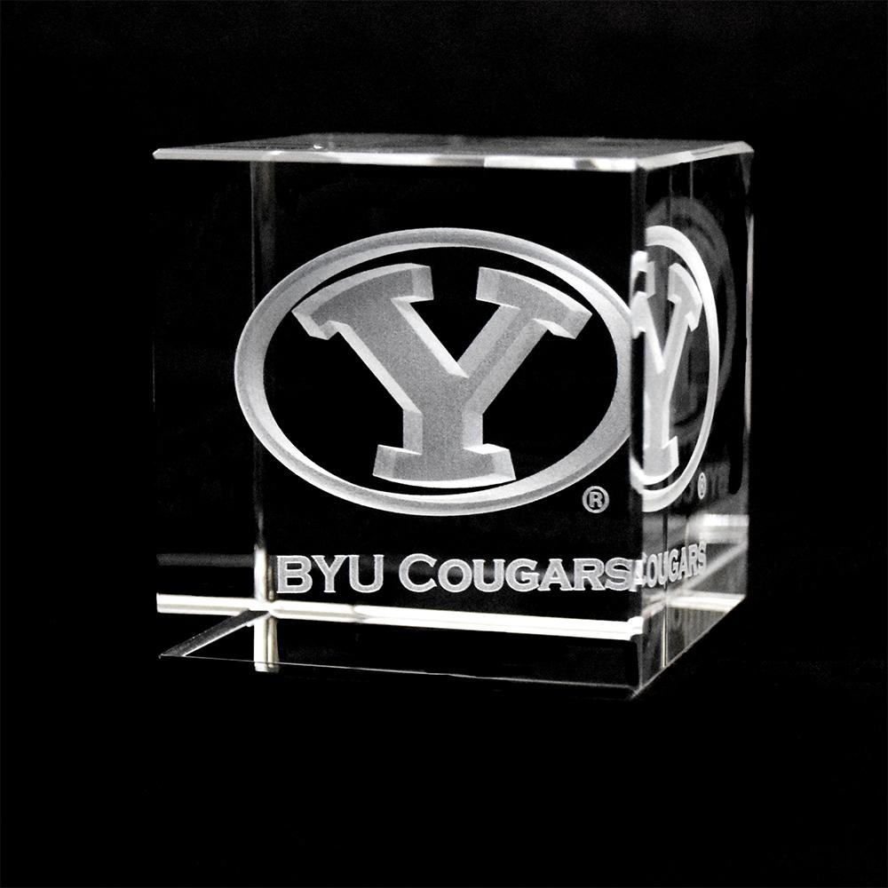 A beautifully crafted BYU Crystal Cube showcasing the BYU logo inside a clear optical crystal, reflecting light with sharp angles.