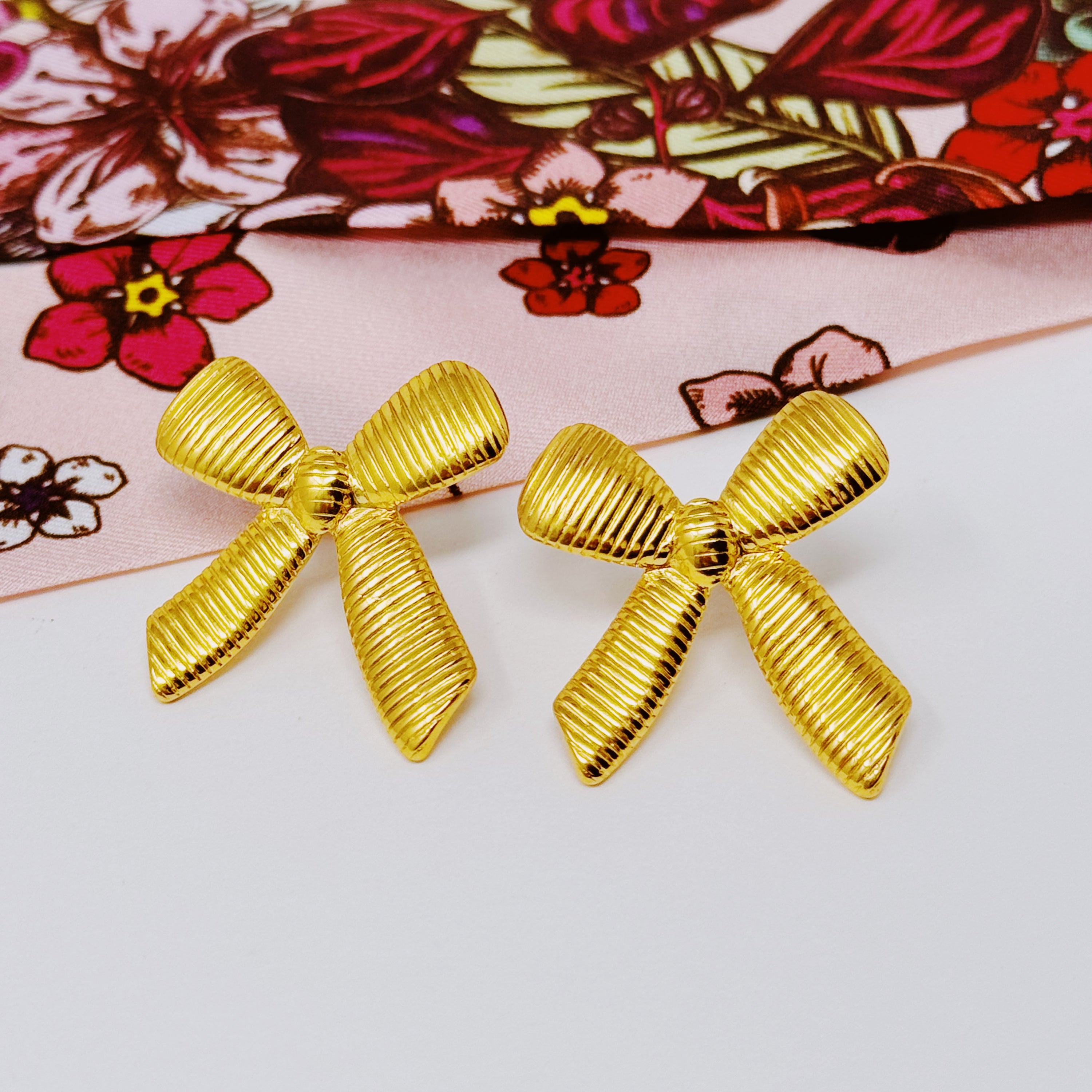 Elegant Cabled Bow Stud Earrings in 18k gold plated stainless steel, showcasing a unique cabling design.