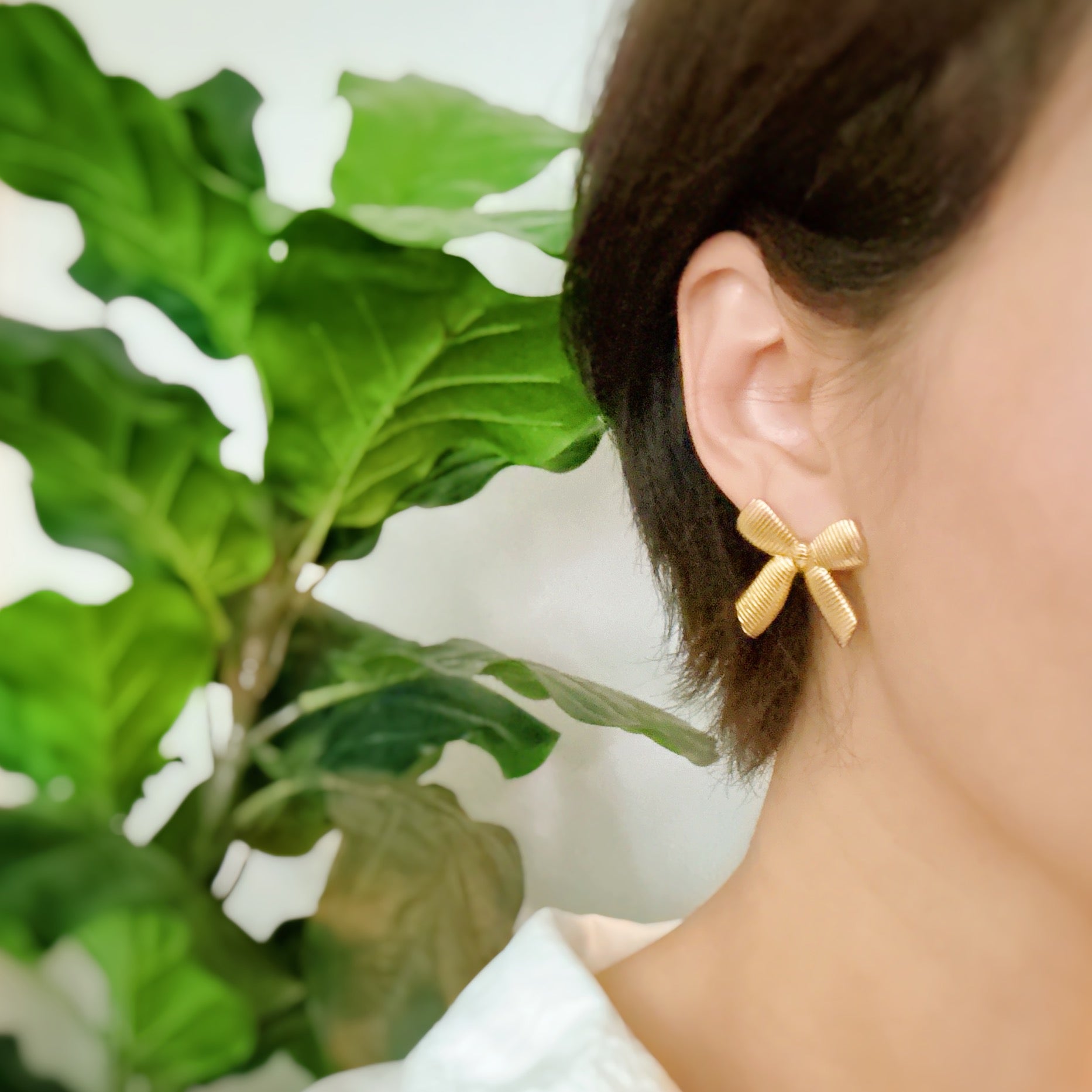 Elegant Cabled Bow Stud Earrings in 18k gold plated stainless steel, showcasing a unique cabling design.