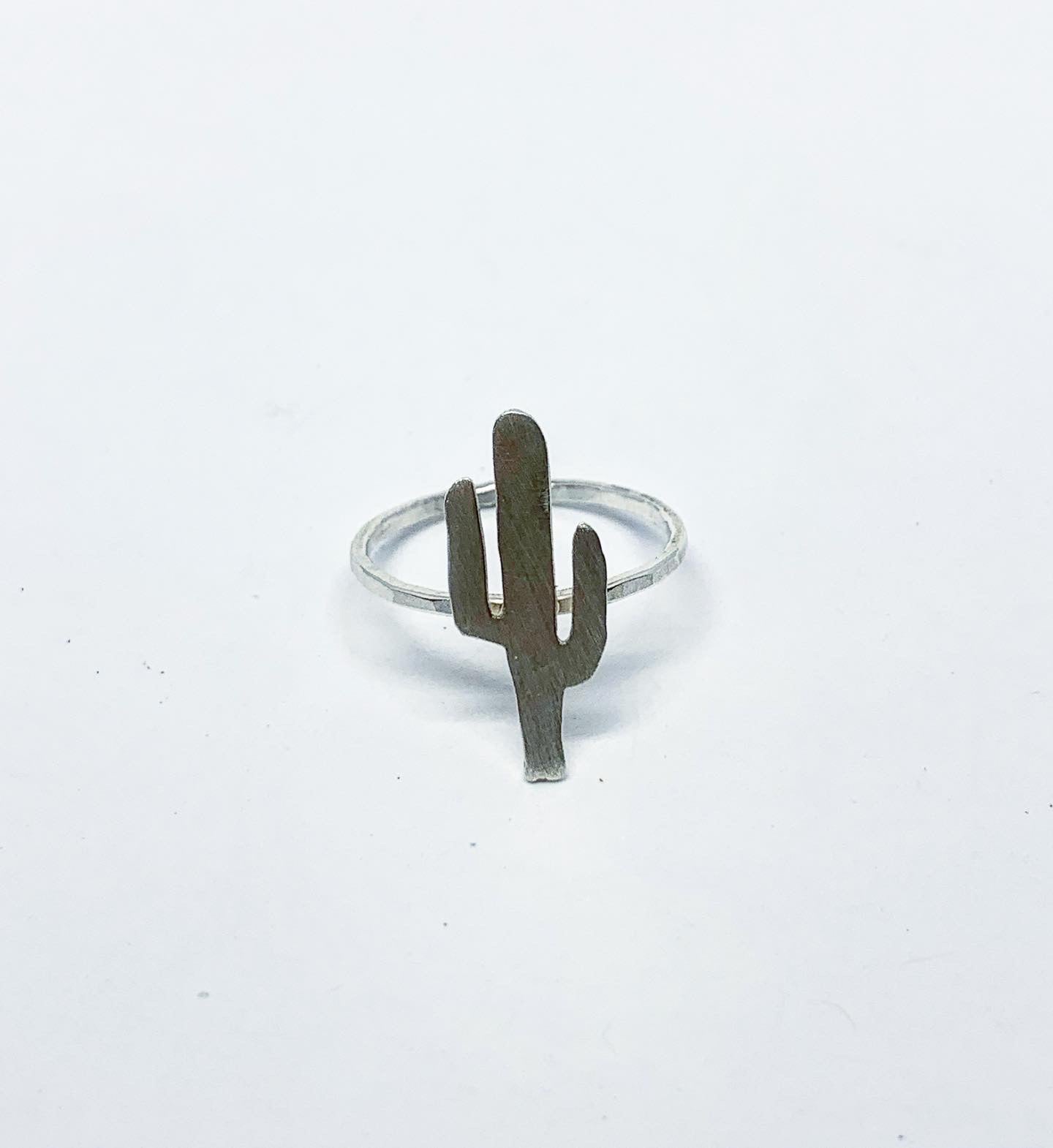 A whimsical sterling silver cactus ring, handcrafted with intricate details, inspired by nature's beauty.