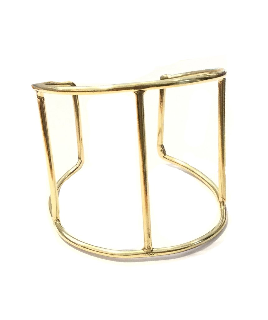 A stylish Cage Cuff Bracelet in gold and silver, showcasing its minimalist design and adjustable fit.