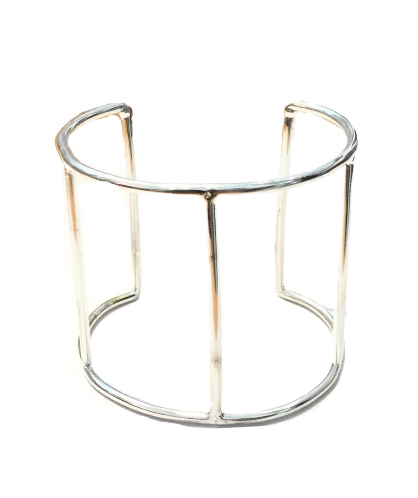 A stylish Cage Cuff Bracelet in gold and silver, showcasing its minimalist design and adjustable fit.