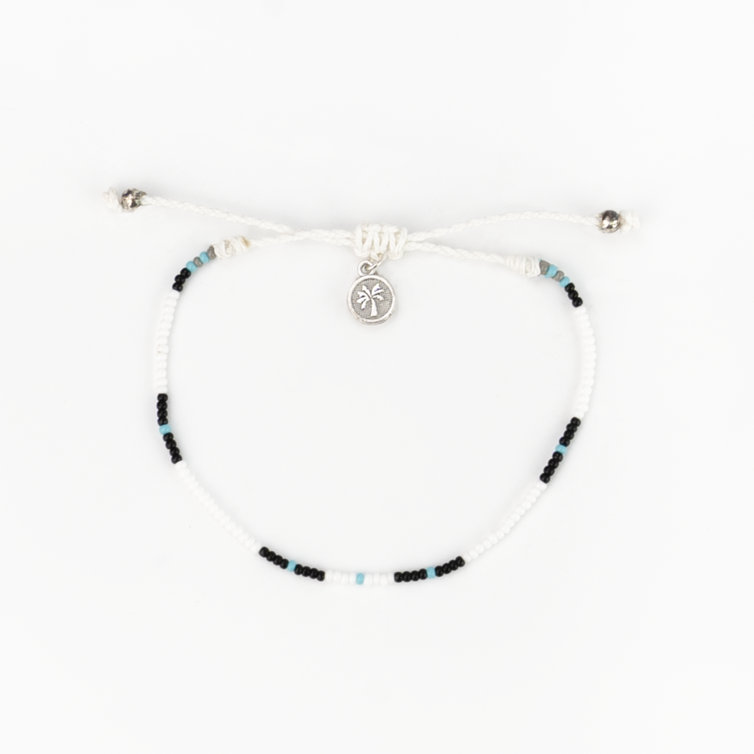 A vibrant handmade Cali Surf Anklet in white featuring multi-colored beads on a silk string, perfect for summer and beach activities.