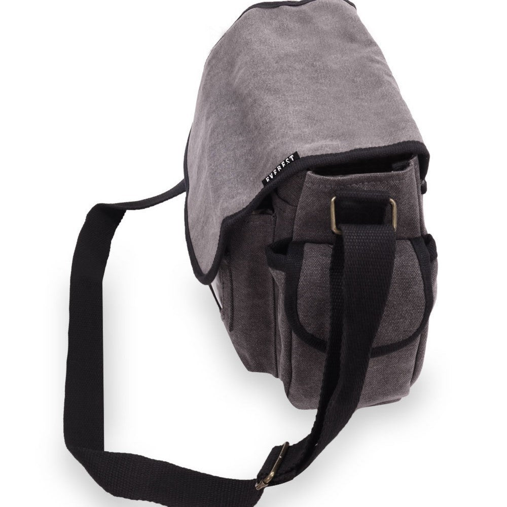 A large cotton canvas messenger bag with two side pockets and a front flap, showcasing its spacious design and stylish appearance.