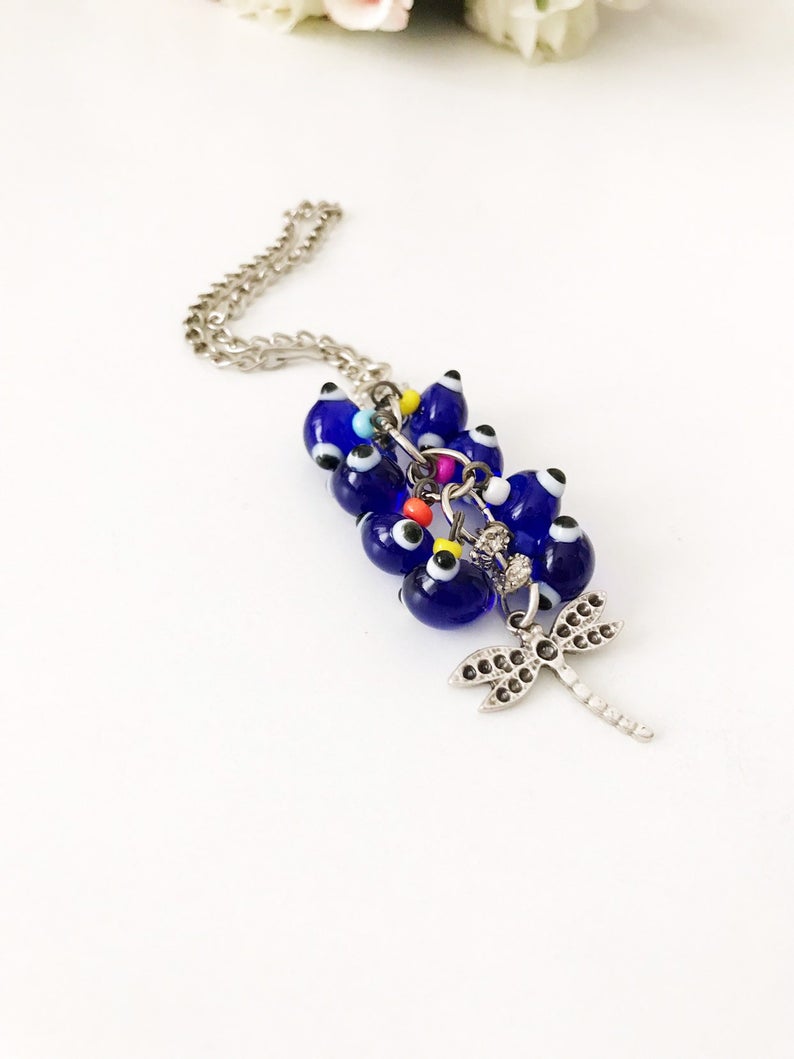 Handmade car rear view mirror charm featuring a dragonfly design, glass beads, and a silver charm, perfect for adding elegance to your vehicle.