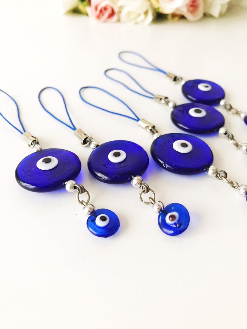 Handmade car rear view mirror charm featuring blue glass evil eye beads, symbolizing protection and good luck.