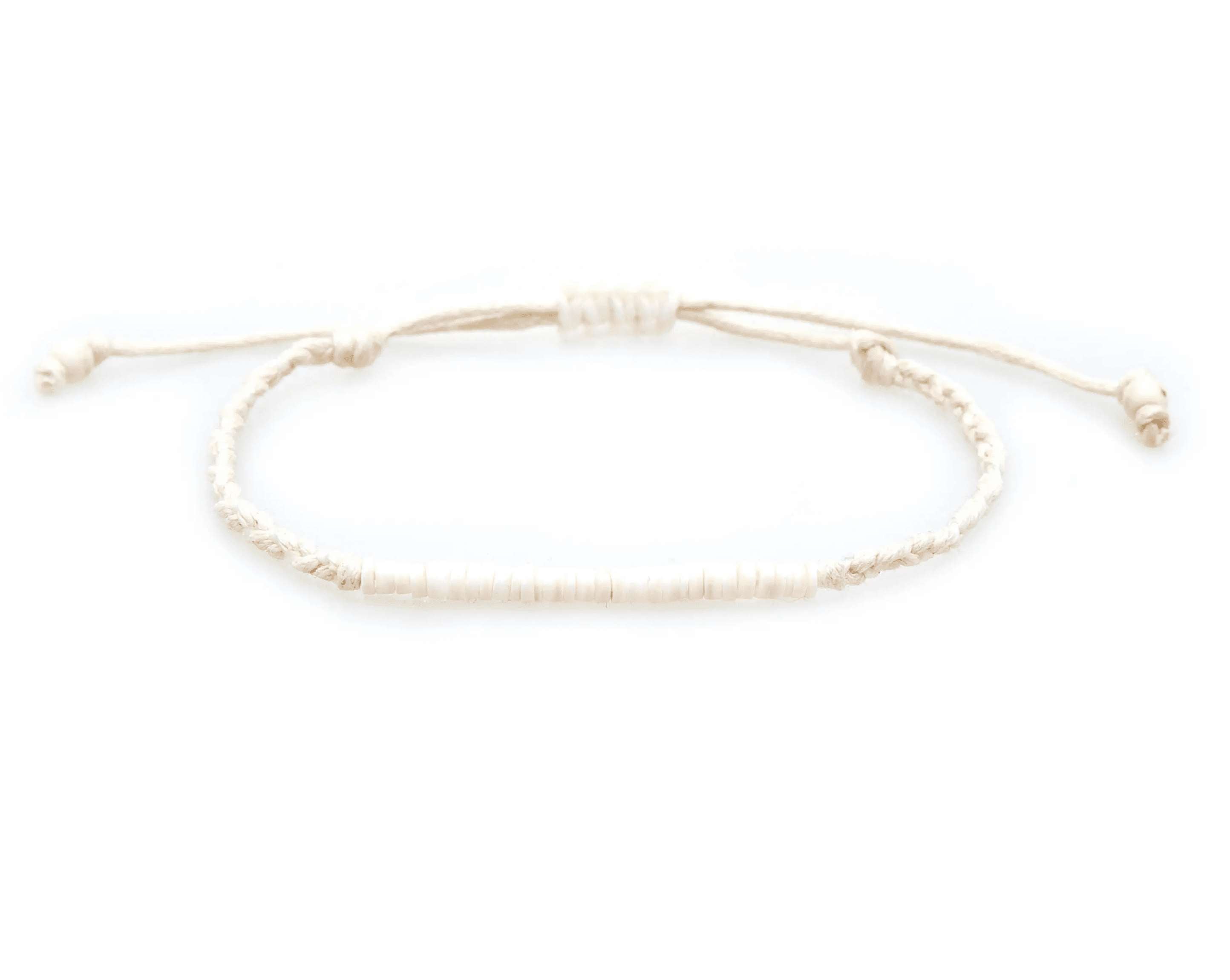 Carissa Braided Puka Bracelet featuring cotton cords, coconut shell clasps, and puka shell beads in natural tones.