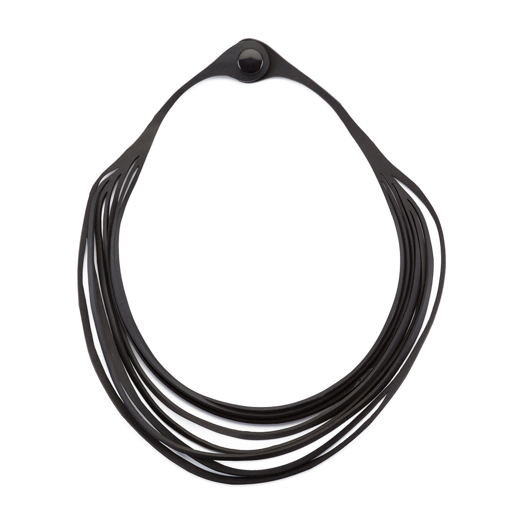 Carter Layered Recycled Rubber Necklace showcasing its unique multi-strap design and texture from recycled tyre inner tubes.