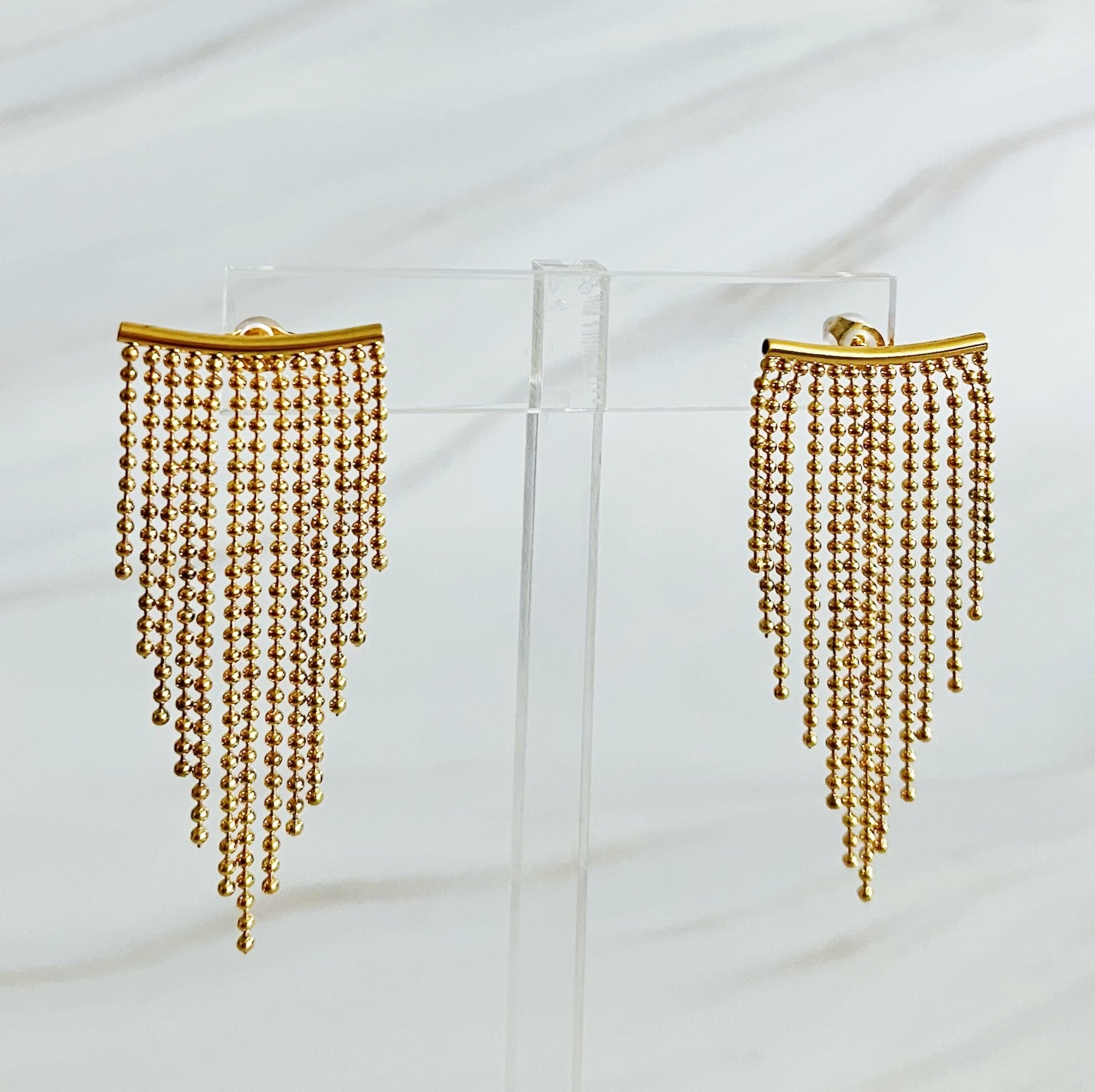 Elegant Cascade Draping Earrings featuring intricate design and sparkling cubic zirconia accents, crafted from 18k gold plated stainless steel.