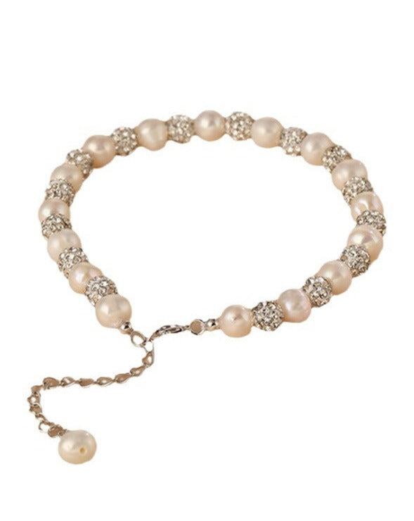 Celestial Charm Dazzling Star Pearl Bracelet featuring lustrous 6mm pearls, designed to resemble twinkling stars against a dark background.