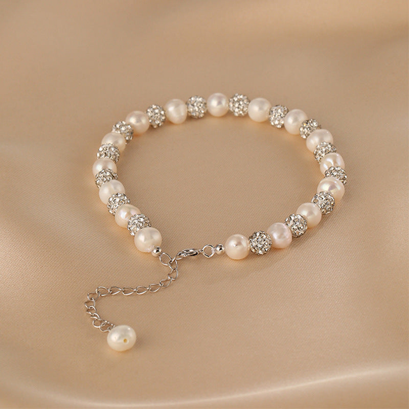 Celestial Charm Dazzling Star Pearl Bracelet featuring lustrous 6mm pearls, designed to resemble twinkling stars against a dark background.