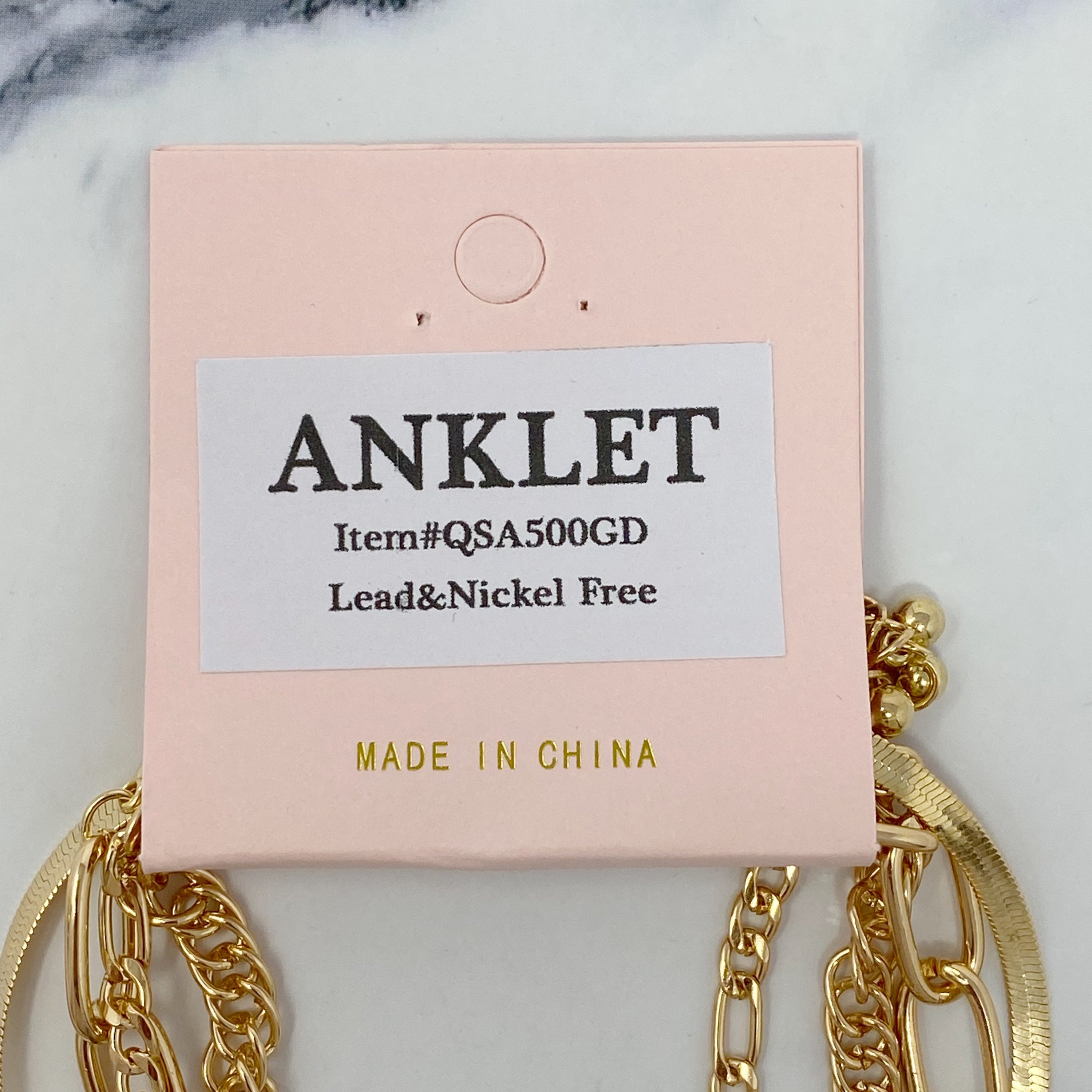 A stylish chain anklet set featuring four individual gold plated anklets, perfect for layering or wearing separately.