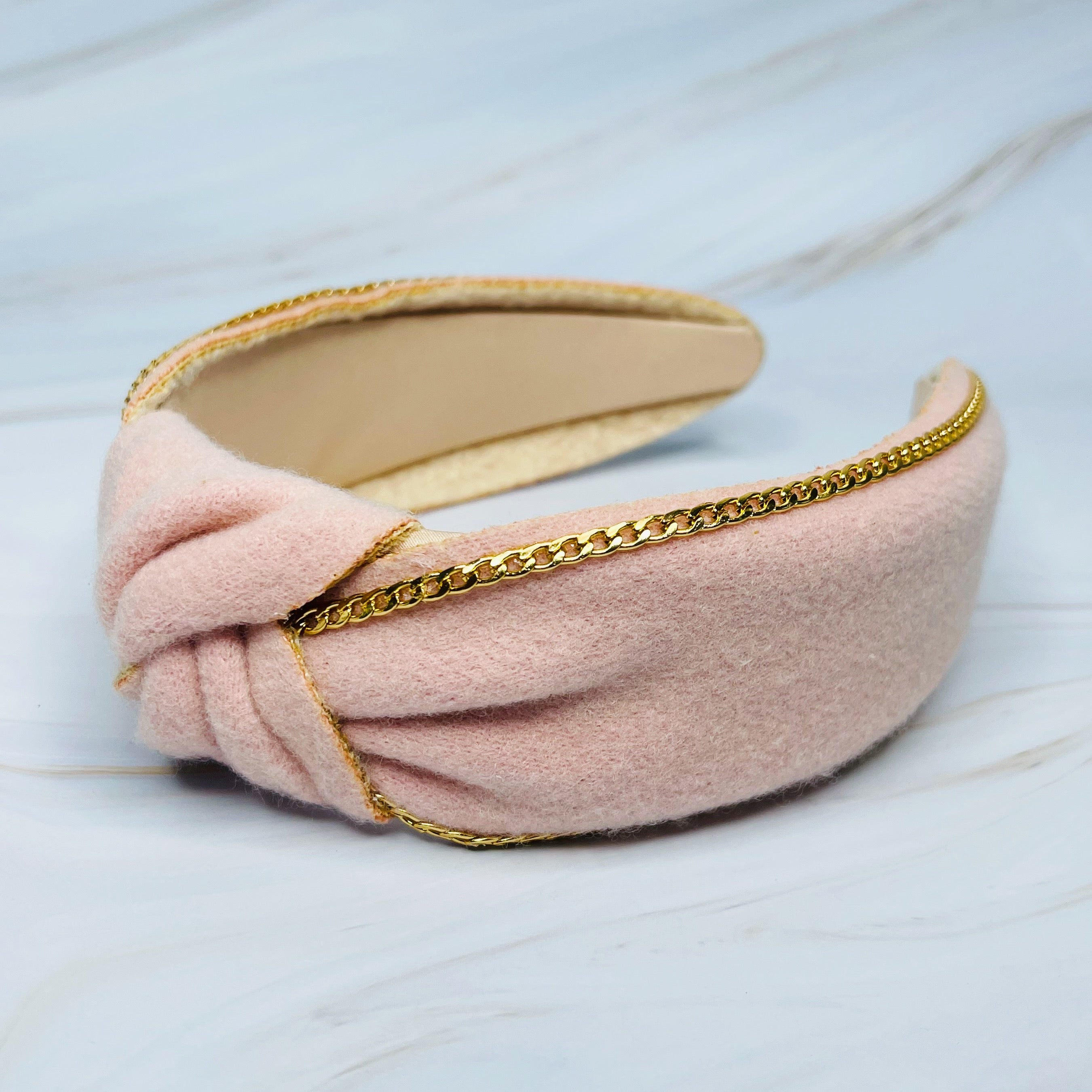 Chained In Line Headband featuring gold chain embellishment, soft fabric, and stylish design.